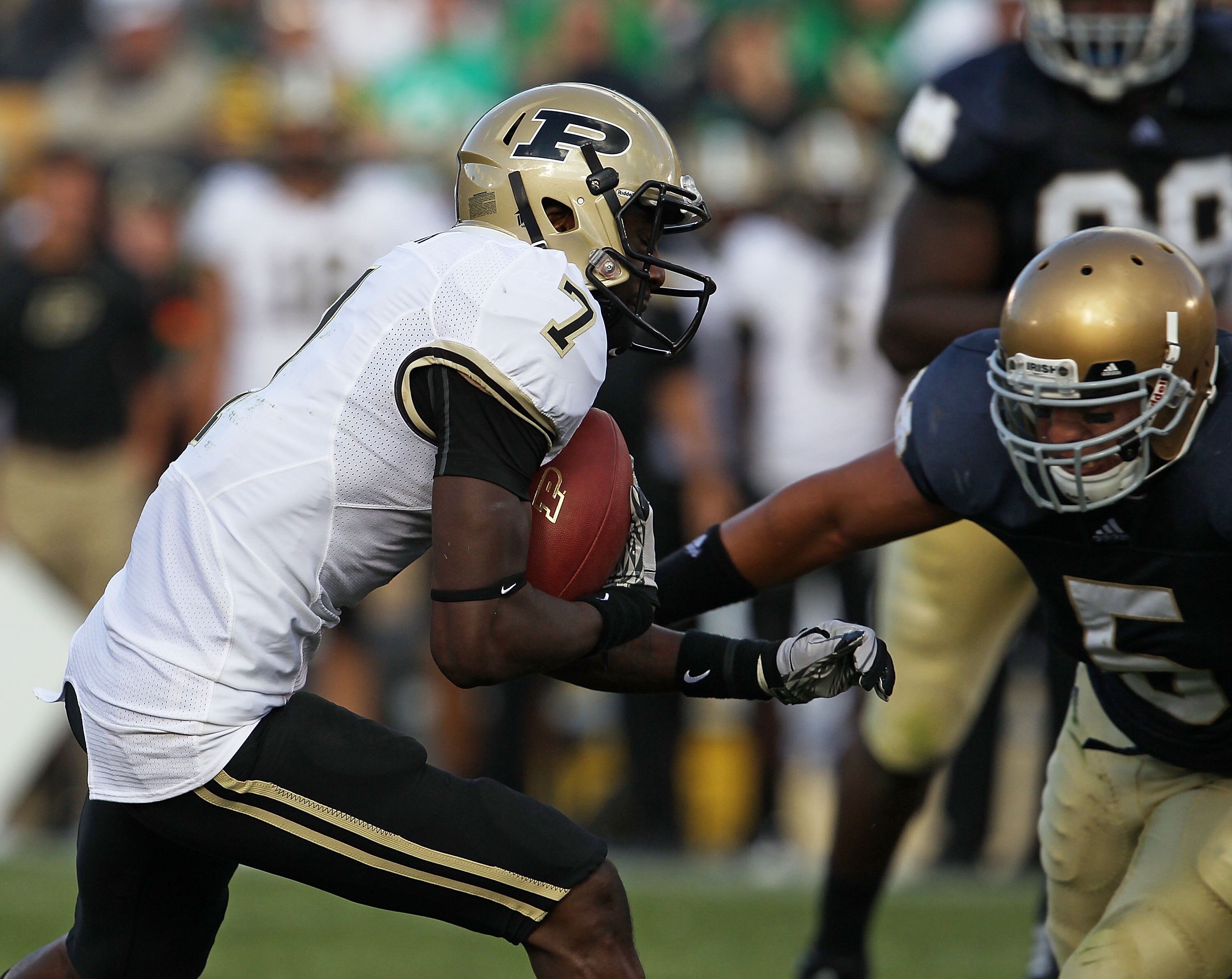 SOUTH BEND, IN - SEPTEMBER 04: Cortez Smith #7 of the Purdue Boilermakers moves for yardage as Manti Te'o #5 of the Notre Dame Fighting Irish closes in at Notre Dame Stadium on September 4, 2010 in South Bend, Indiana. Notre Dame defeated Purdue 23-12. (P