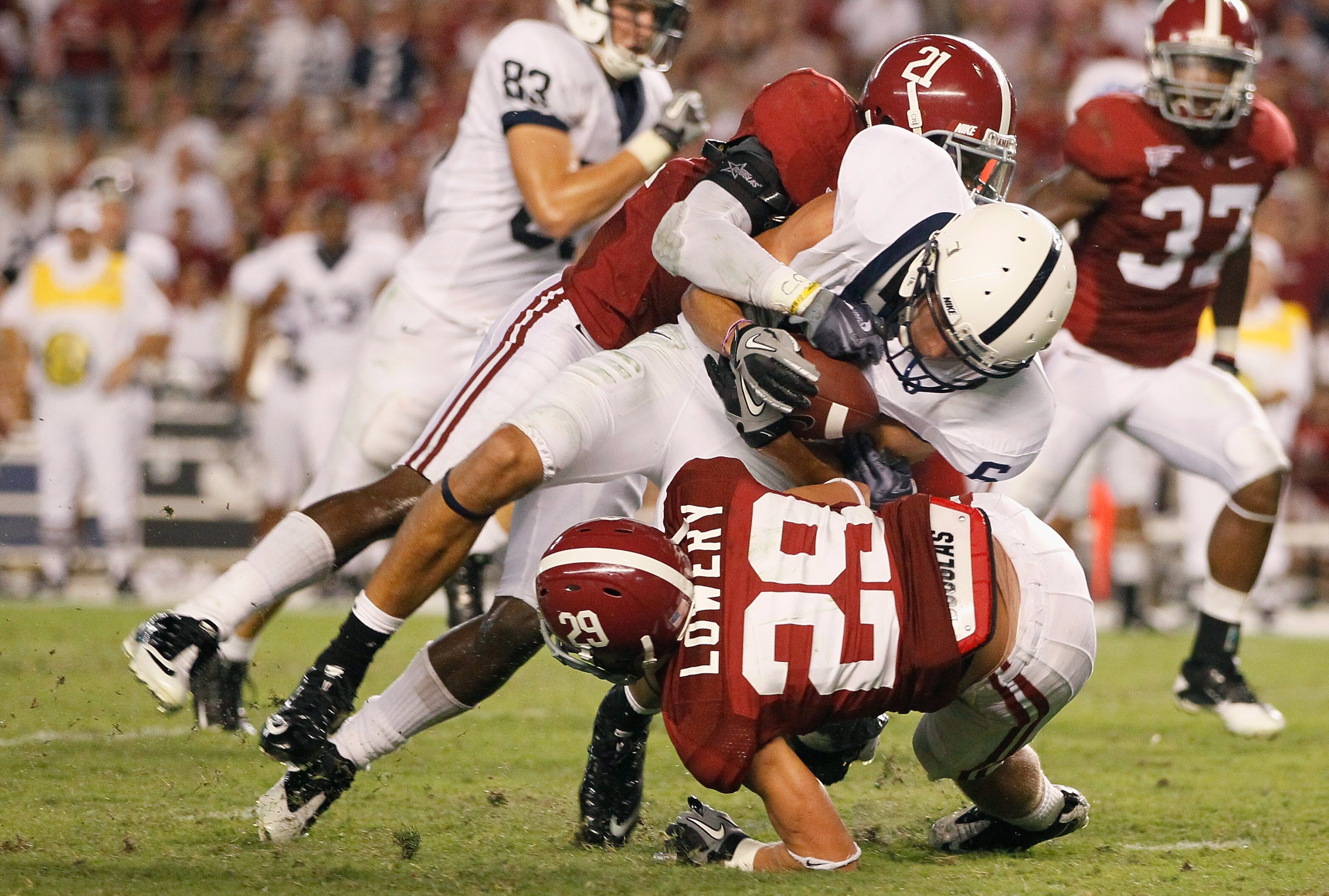 TUSCALOOSA, AL - SEPTEMBER 11:  Dre Kirkpatrick #21 and Will Lowery #29 of the Alabama Crimson Tide tackle Derek Moye #6 of the Penn State Nittany Lions at Bryant-Denny Stadium on September 11, 2010 in Tuscaloosa, Alabama.  (Photo by Kevin C. Cox/Getty Im