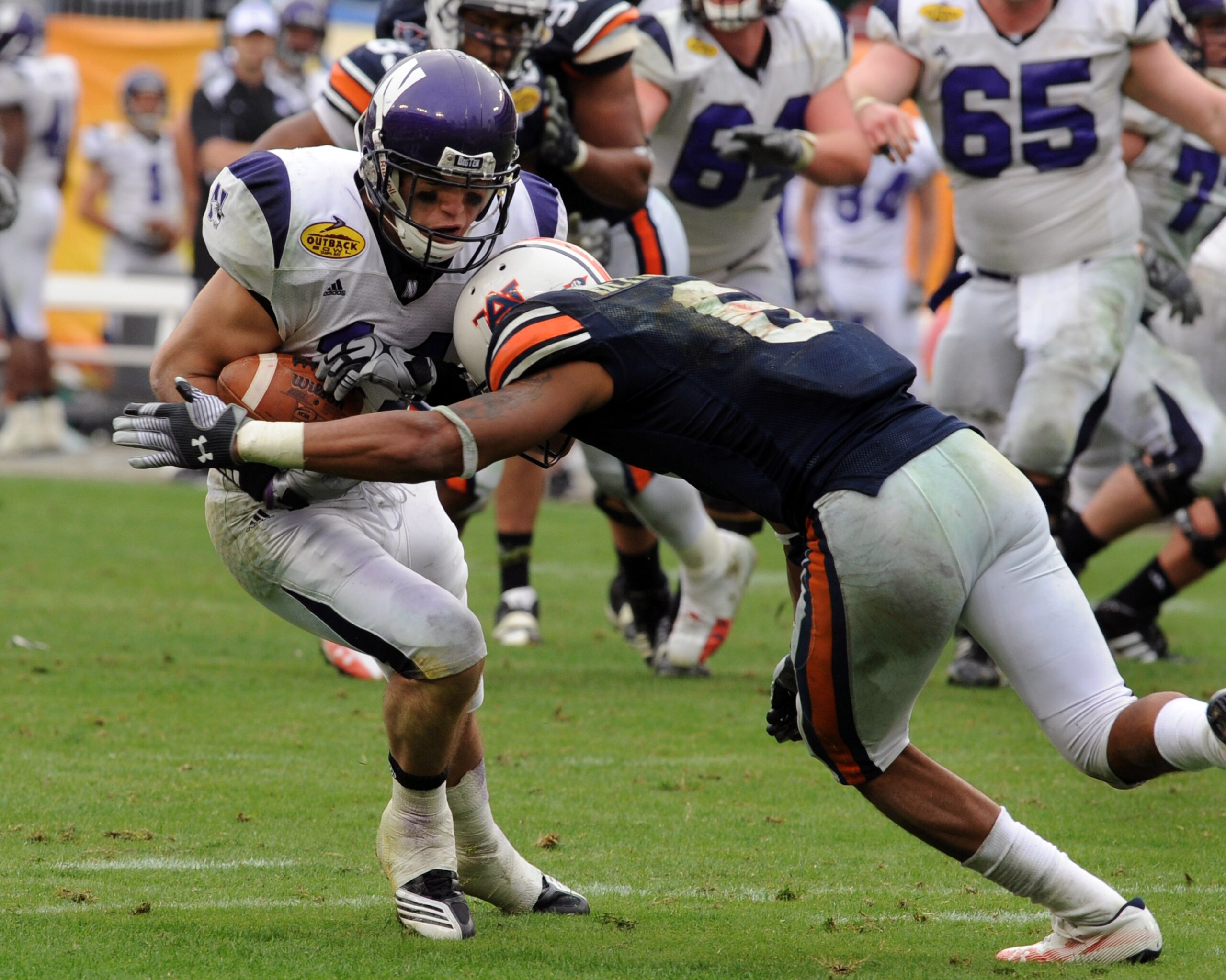 TAMPA, FL - JANUARY 1: Wide receiver Jeremy Ebert #11 of the Northwestern Wildcats grabs a pass against the Auburn Tigers in the Outback Bowl January 1, 2010 at Raymond James Stadium in Tampa, Florida.  (Photo by Al Messerschmidt/Getty Images)