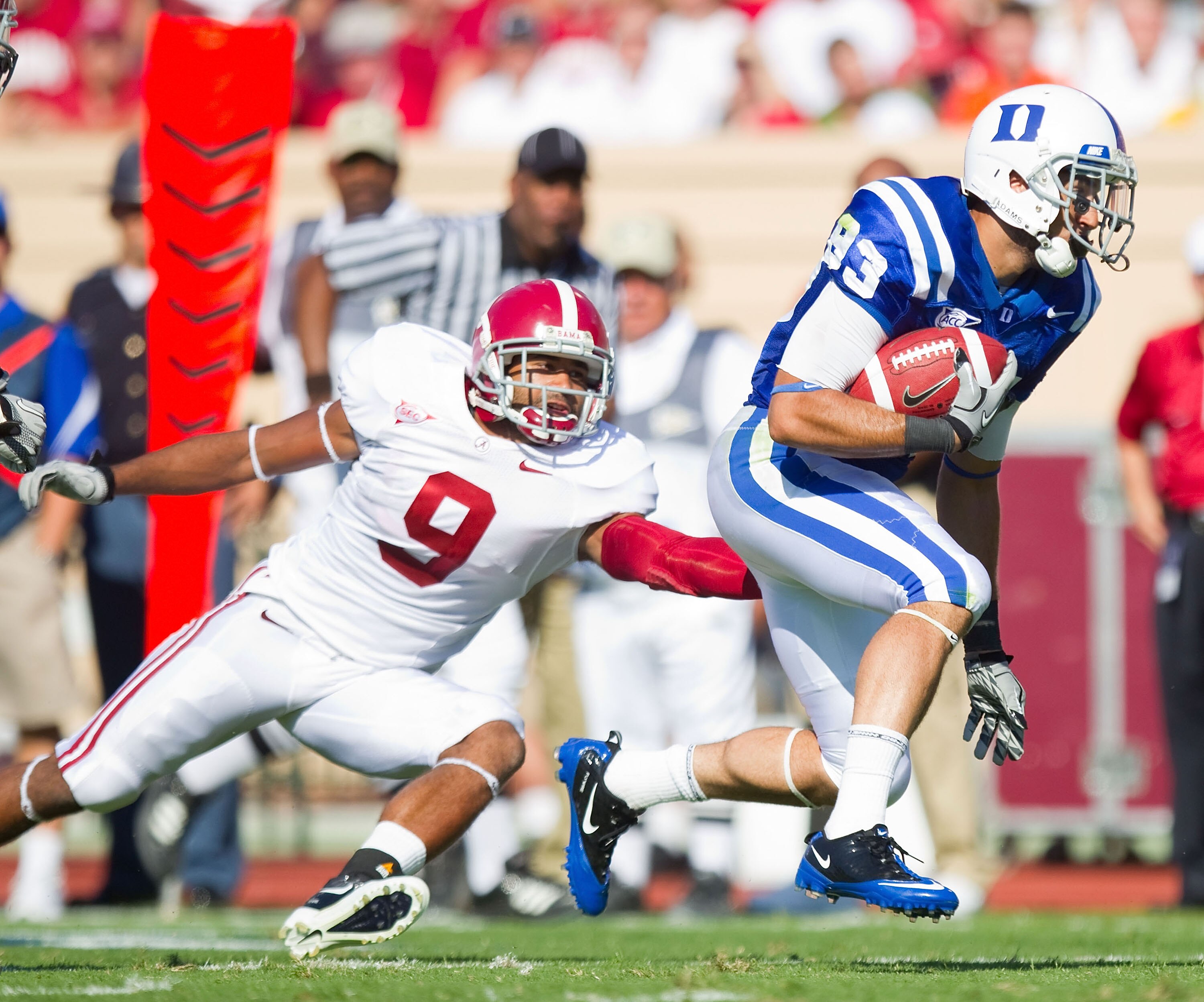 DURHAM, NC - SEPTEMBER 18: Austin Kelly #83 of the Duke Blue Devils runs away from Phelon Jones #9 of the Alabama Crimson Tide at Wallace Wade Stadium on September 18, 2010 in Durham, North Carolina. The Crimson Tide defeated the Blue Devils 62-13. (Pho DURHAM, NC - SEPTEMBER 18: Austin Kelly #83 of the Duke Blue Devils runs away from Phelon Jones #9 of the Alabama Crimson Tide at Wallace Wade Stadium on September 18, 2010 in Durham, North Carolina. The Crimson Tide defeated the Blue Devils 62-13. (Pho