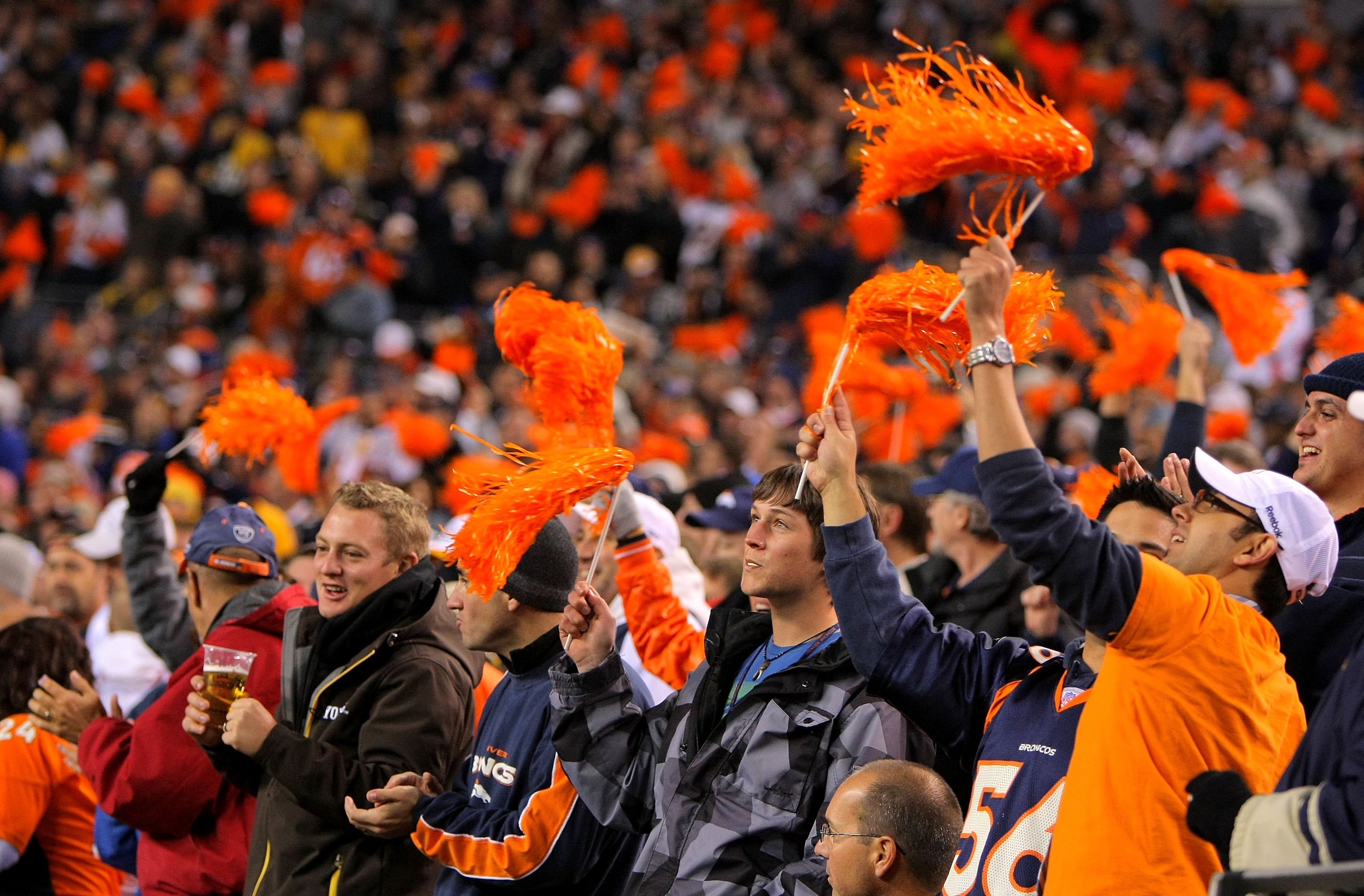 DENVER - NOVEMBER 09:  Fans support the Denver Broncos against the Pittsburgh Steelers defense on during NFL action at Invesco Field at Mile High on November 9, 2009 in Denver, Colorado. The Steelers defeated the Broncos 28-10.  (Photo by Doug Pensinger/G