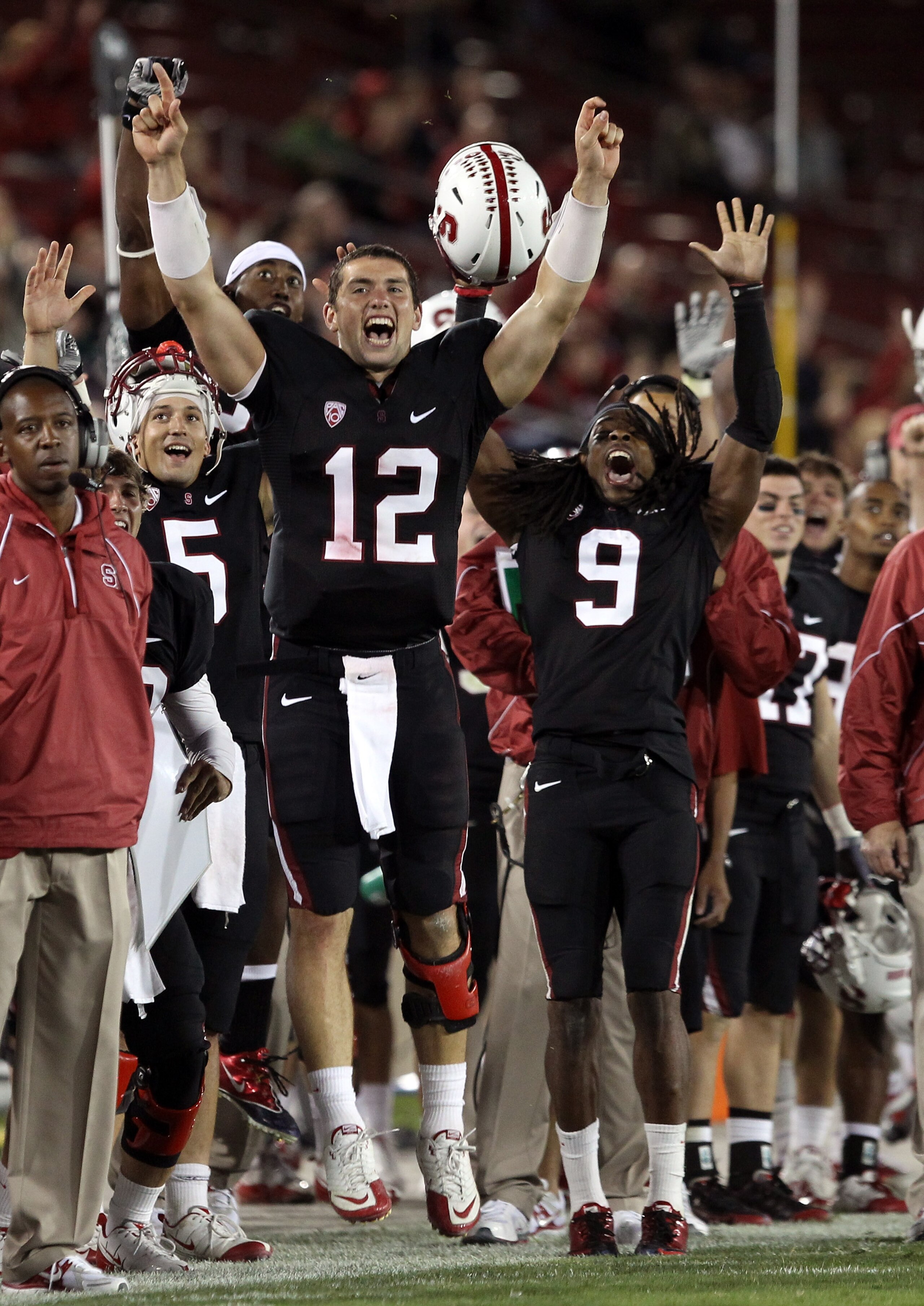 PALO ALTO, CA - SEPTEMBER 18:  Andrew Luck #12 and Richard Sherman #9 of the Stanford Cardinal celebrate from the sidelines after Stanford scored a touchdown to go up 67-24 in the fourth quarter of their game against the Wake Forest Demon Deacons at Stanf