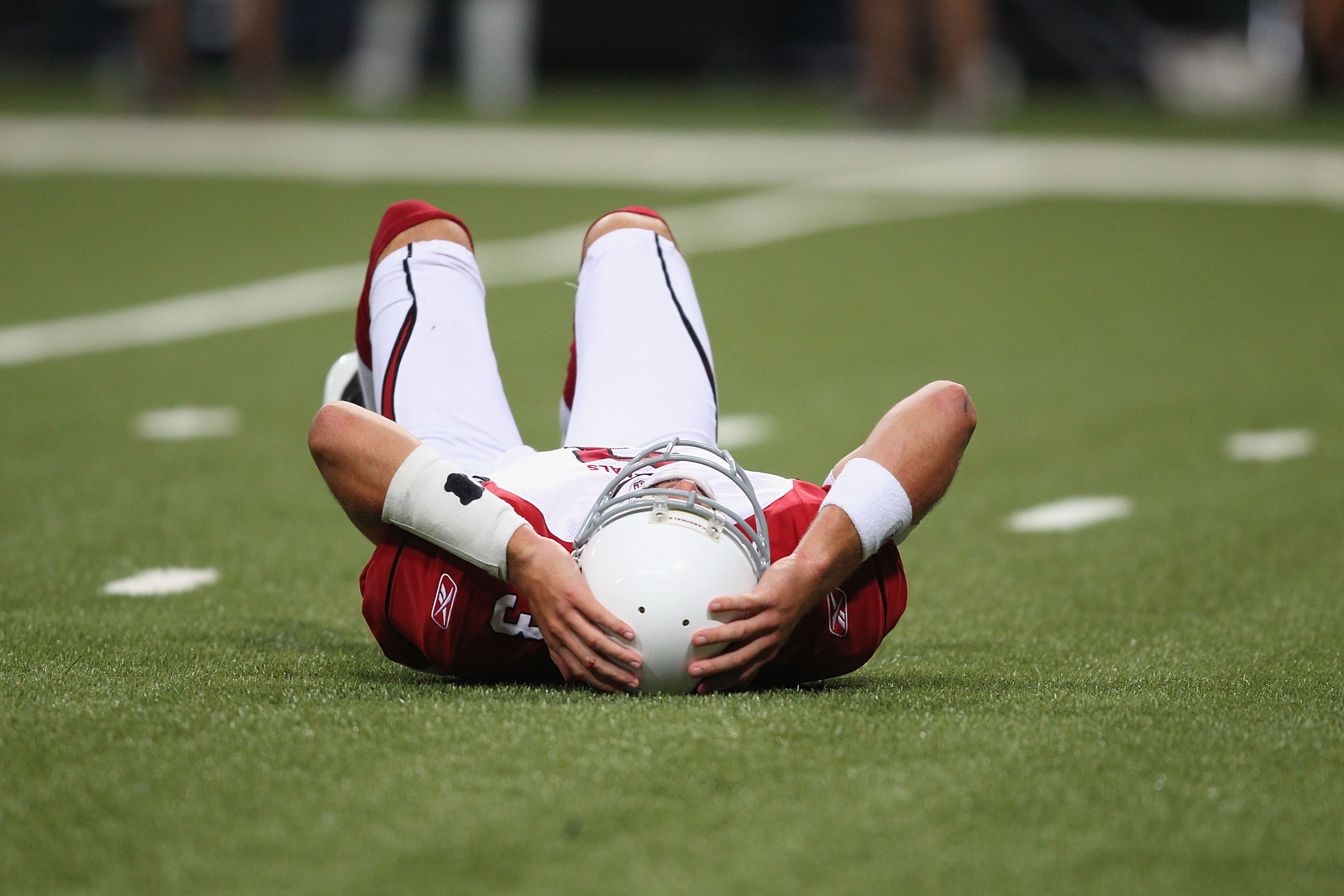 ST. LOUIS - SEPTEMBER 12: Derek Anderson #3 of the Arizona Cardinals lays on the ground after being sacked against the St. Louis Rams during the NFL season opener at the Edward Jones Dome on September 12, 2010 in St. Louis, Missouri.  The Cardinals beat t