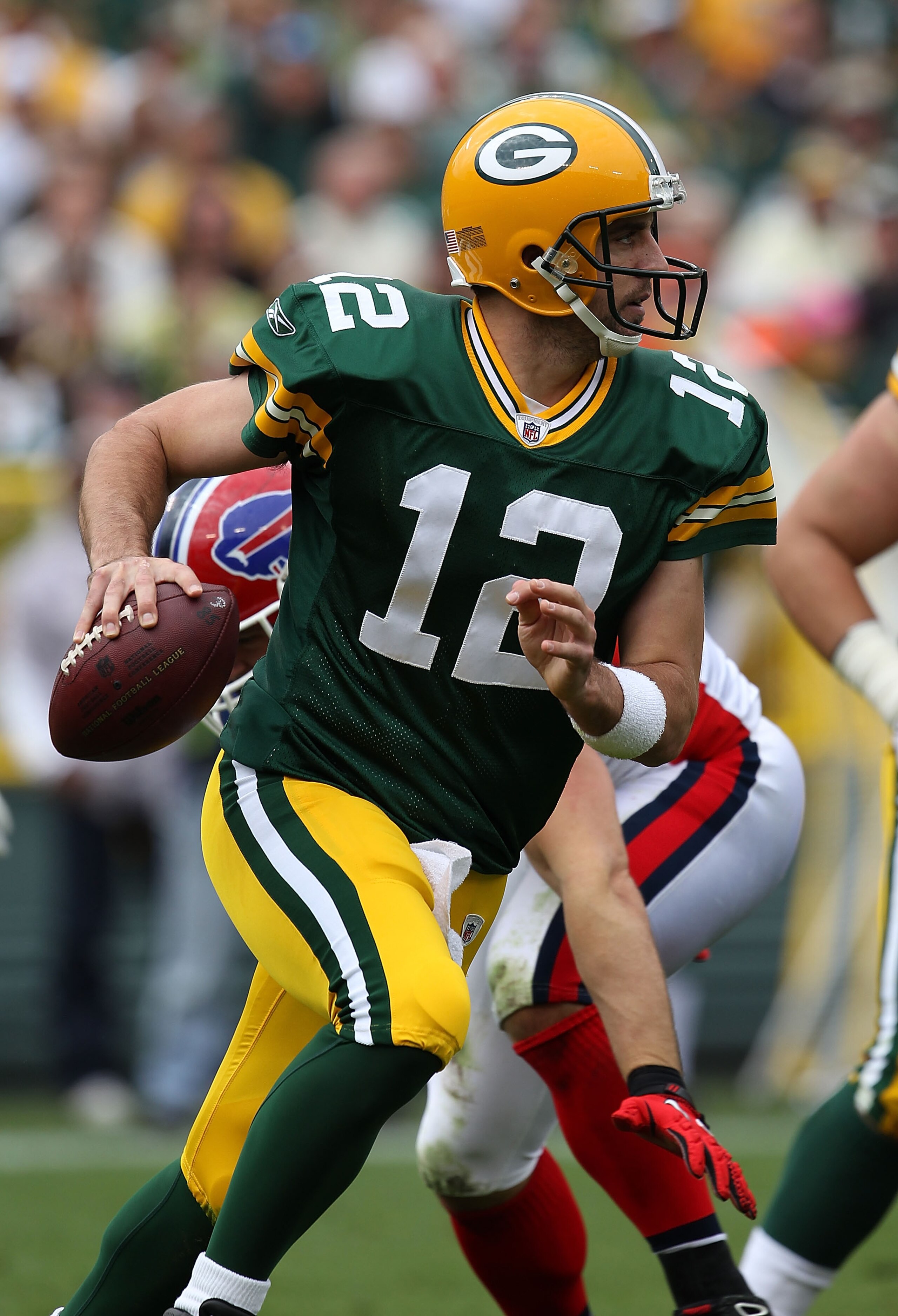 GREEN BAY, WI - SEPTEMBER 19: Aaron Rodgers #12 of the Green Bay Packers rolls out to look for a receiver against the Buffalo Bills at Lambeau Field on September 19, 2010 in Green Bay, Wisconsin. The Packers defeated the Bills 34-7. (Photo by Jonathan Dan