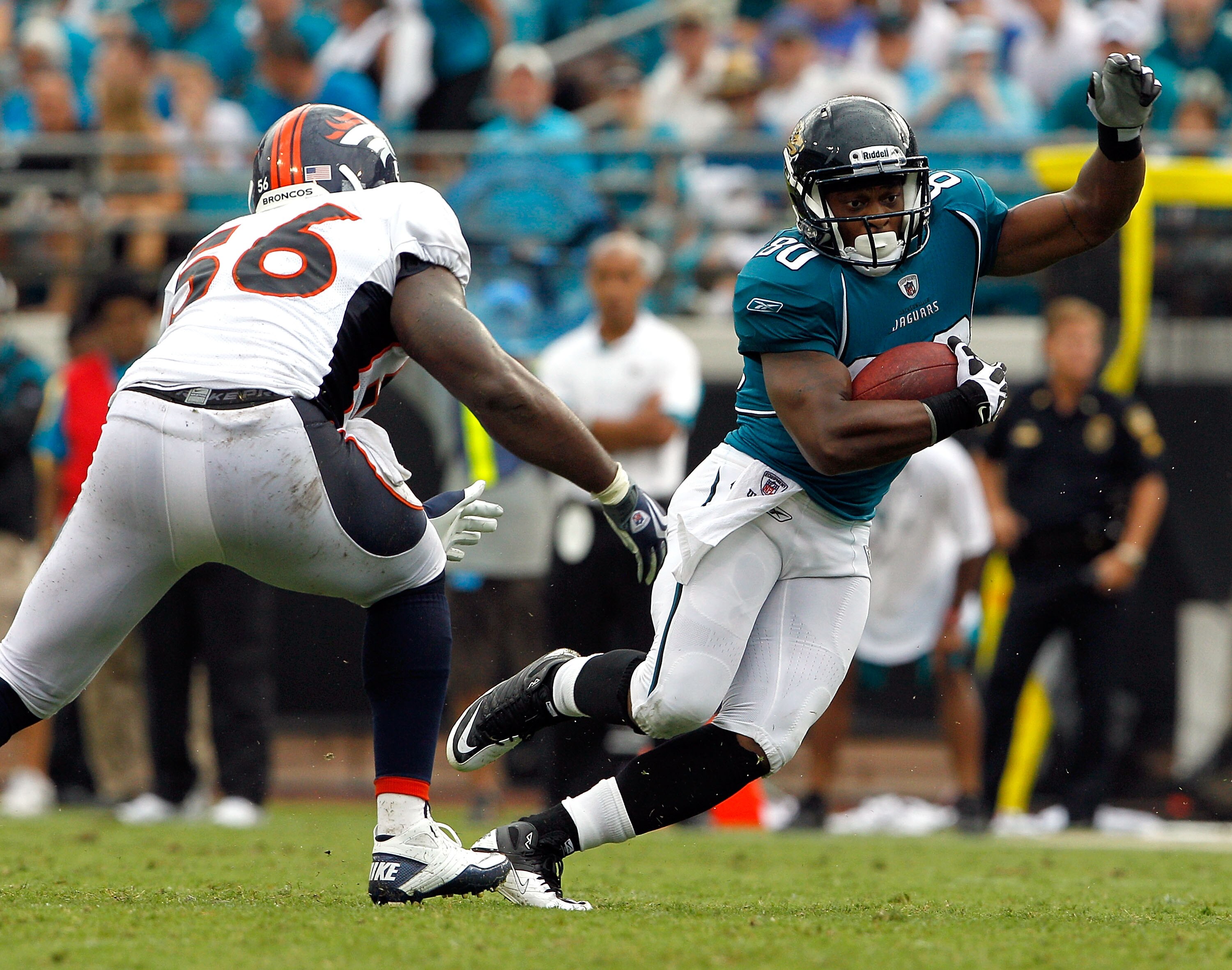 JACKSONVILLE, FL - SEPTEMBER 12:  Robert Ayers #56 of the Denver Broncos attempts to tackle Mike Thomas #80 of the Jacksonville Jaguars during the NFL season opener game at EverBank Field on September 12, 2010 in Jacksonville, Florida.  (Photo by Sam Gree