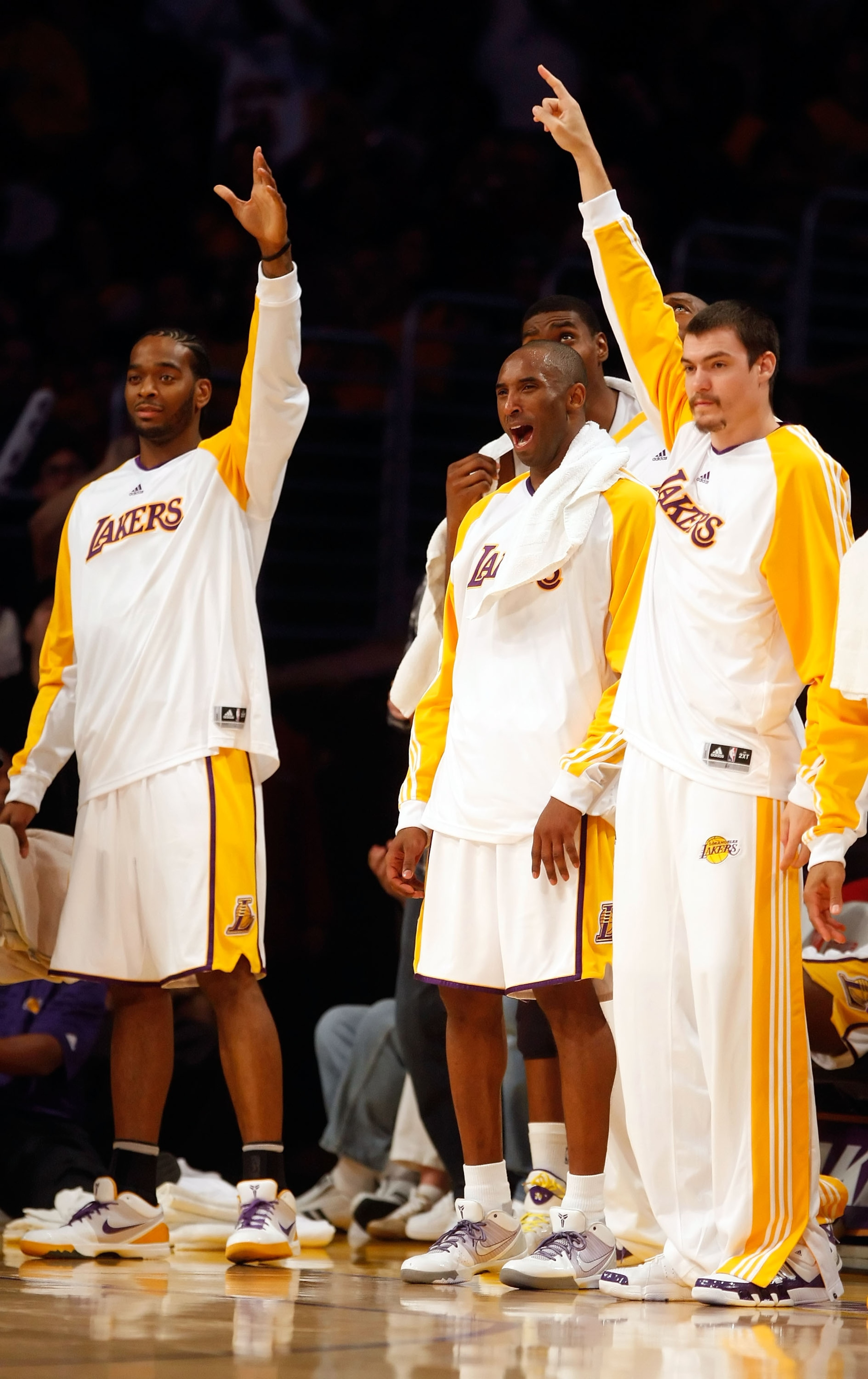 LOS ANGELES, CA - NOVEMBER 22:  (L-R) Josh Powell #21, Kobe Bryant #24 and Adam Morrison #6 of the Los Angeles Lakers celebrate on the bench in the second half against the Oklahoma City Thunder at Staples Center on November 22, 2009 in Los Angeles, Califo