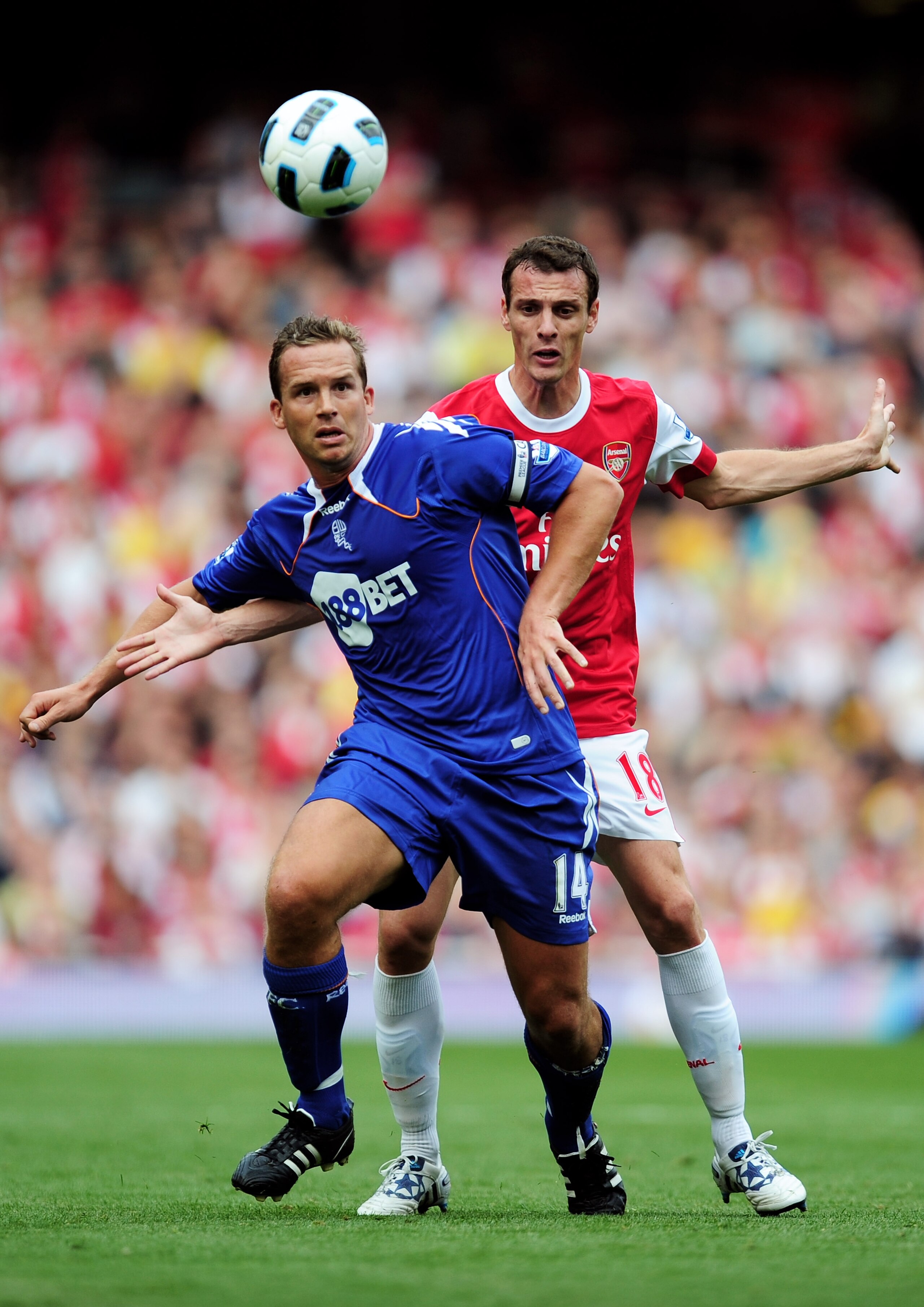 LONDON, ENGLAND - SEPTEMBER 11:  Sebastien Squillaci of Arsenal battles with Kevin Davies of Bolton during the Barclays Premier League match between Arsenal and Bolton Wanderers at The Emirates Stadium on September 11, 2010 in London, England.  (Photo by