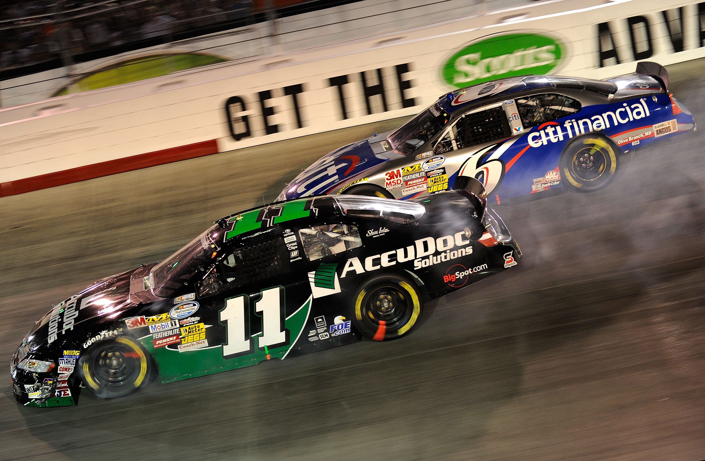 BRISTOL, TN - AUGUST 20:  Brian Scott, driver of the #11 AccuDoc Solutions Toyota, and Ricky Stenhouse Jr., driver of the #6 CitiFinancial Ford, drive during the NASCAR Nationwide Series Food City 250 at Bristol Motor Speedway on August 20, 2010 in Bristo