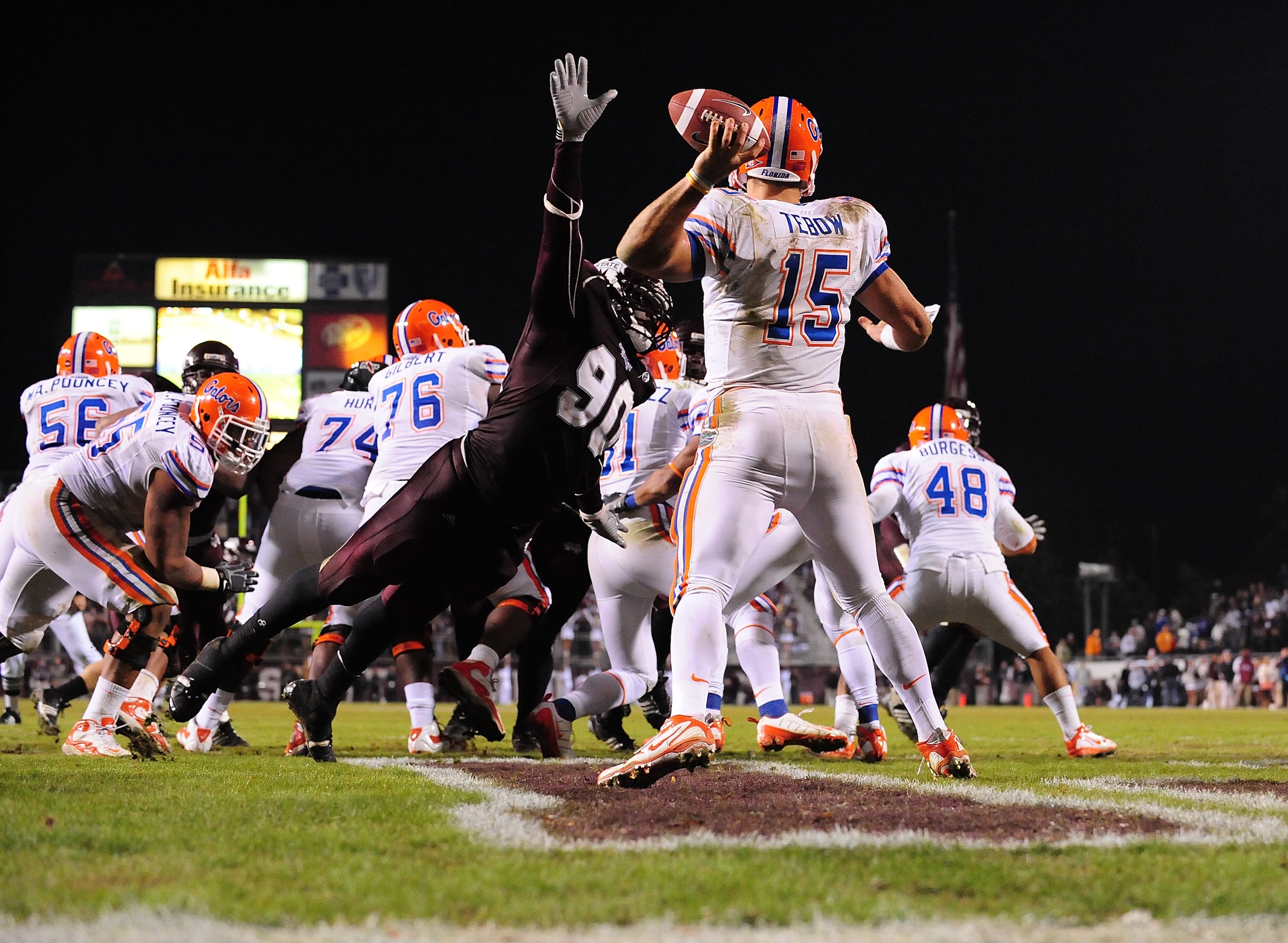 STARKVILLE, MS - OCTOBER 24:  Quarterback Tim Tebow # 15 of the Florida Gators is rushed by Pernell McPhee # 90 of Mississippi State, resulting in an interception return for a touchdown, during the second half, at Davis Wade Stadium on  October 24, 2009 i