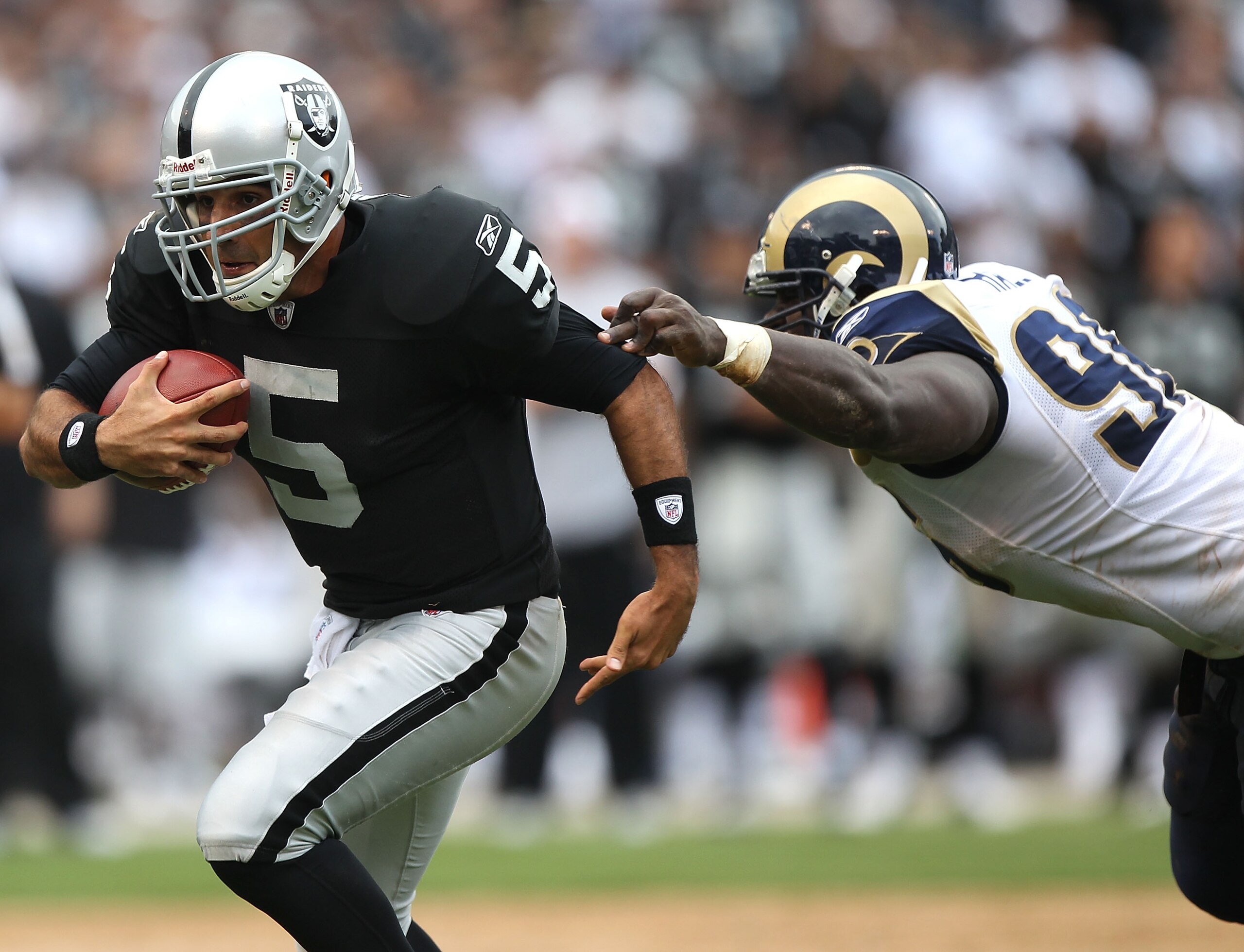 OAKLAND, CA - SEPTEMBER 19: Bruce Gradkowski #5 of the Oakland Raiders runs against James Hall #96 of the St. Louis Rams during an NFL game at Oakland-Alameda County Coliseum on September 19, 2010 in Oakland, California. (Photo by Jed Jacobsohn/Getty Im OAKLAND, CA - SEPTEMBER 19: Bruce Gradkowski #5 of the Oakland Raiders runs against James Hall #96 of the St. Louis Rams during an NFL game at Oakland-Alameda County Coliseum on September 19, 2010 in Oakland, California. (Photo by Jed Jacobsohn/Getty Im