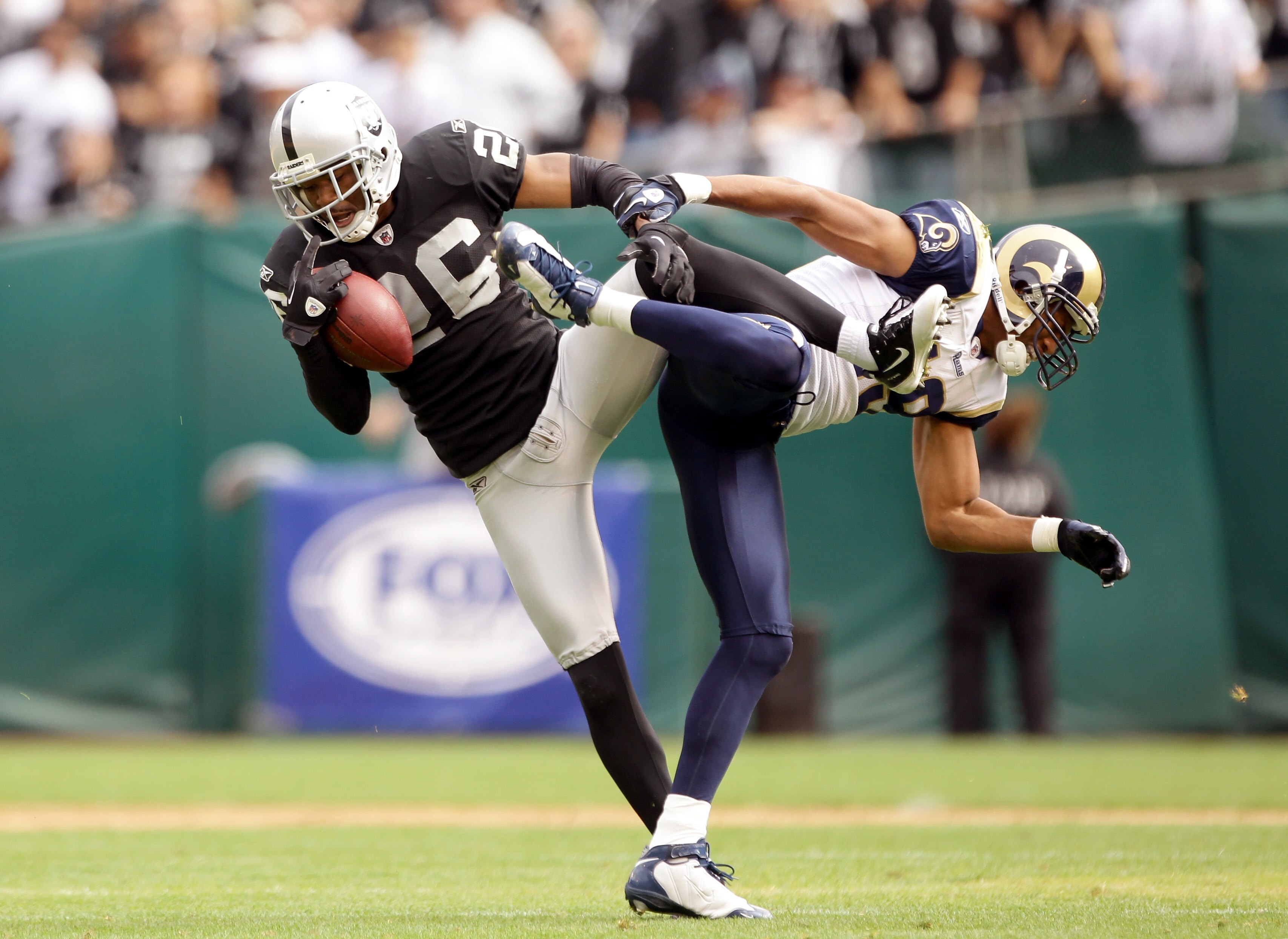 OAKLAND, CA - SEPTEMBER 19:  Stanford Routt #26 of the Oakland Raiders intercepts a pass intended for Laurent Robinson #19 of the St. Louis Rams at the Oakland-Alameda County Coliseum on September 19, 2010 in Oakland, California.  (Photo by Ezra Shaw/Gett