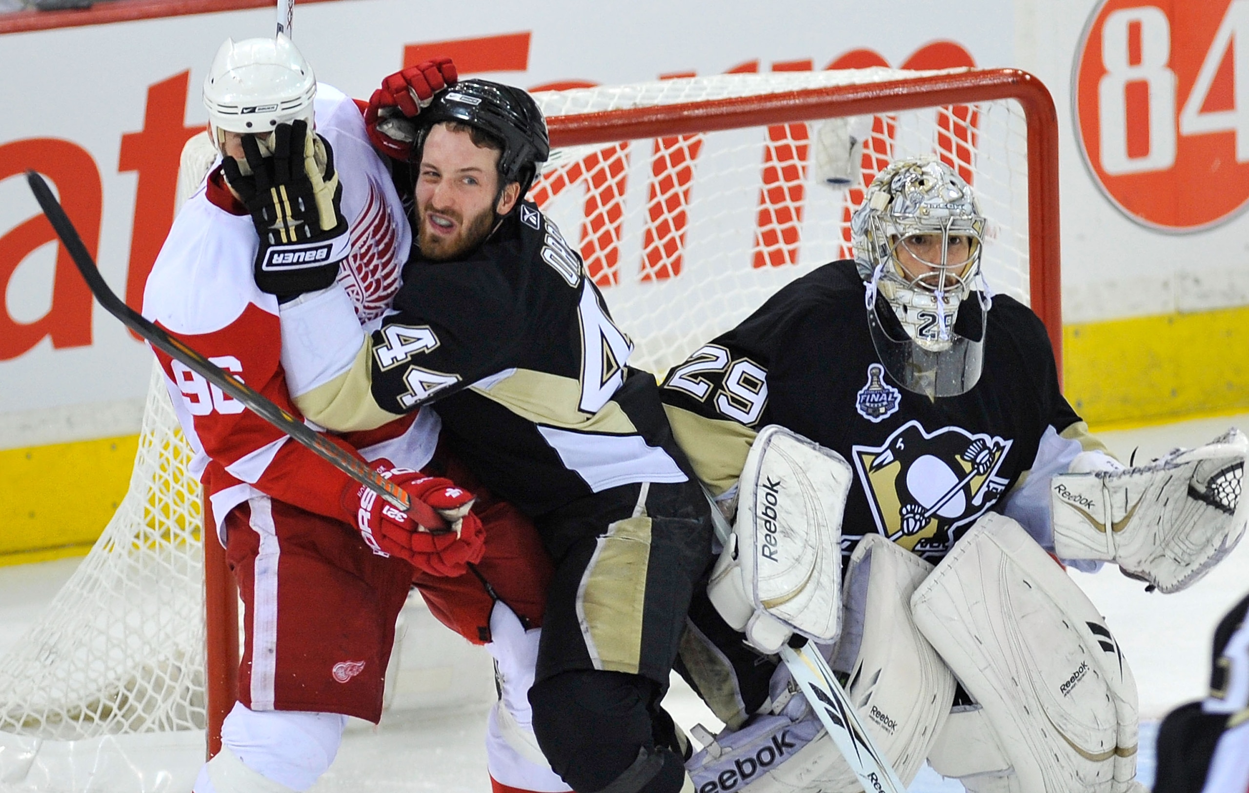 PITTSBURGH - JUNE 09:  Brooks Orpik #44 of the Pittsburgh Penguins defends goaltender Marc-Andre Fleury #29 against Tomas Holmstrom #96 of the Detroit Red Wings during Game Six of the NHL Stanley Cup Finals at the Mellon Arena on June 9, 2009 in Pittsburg