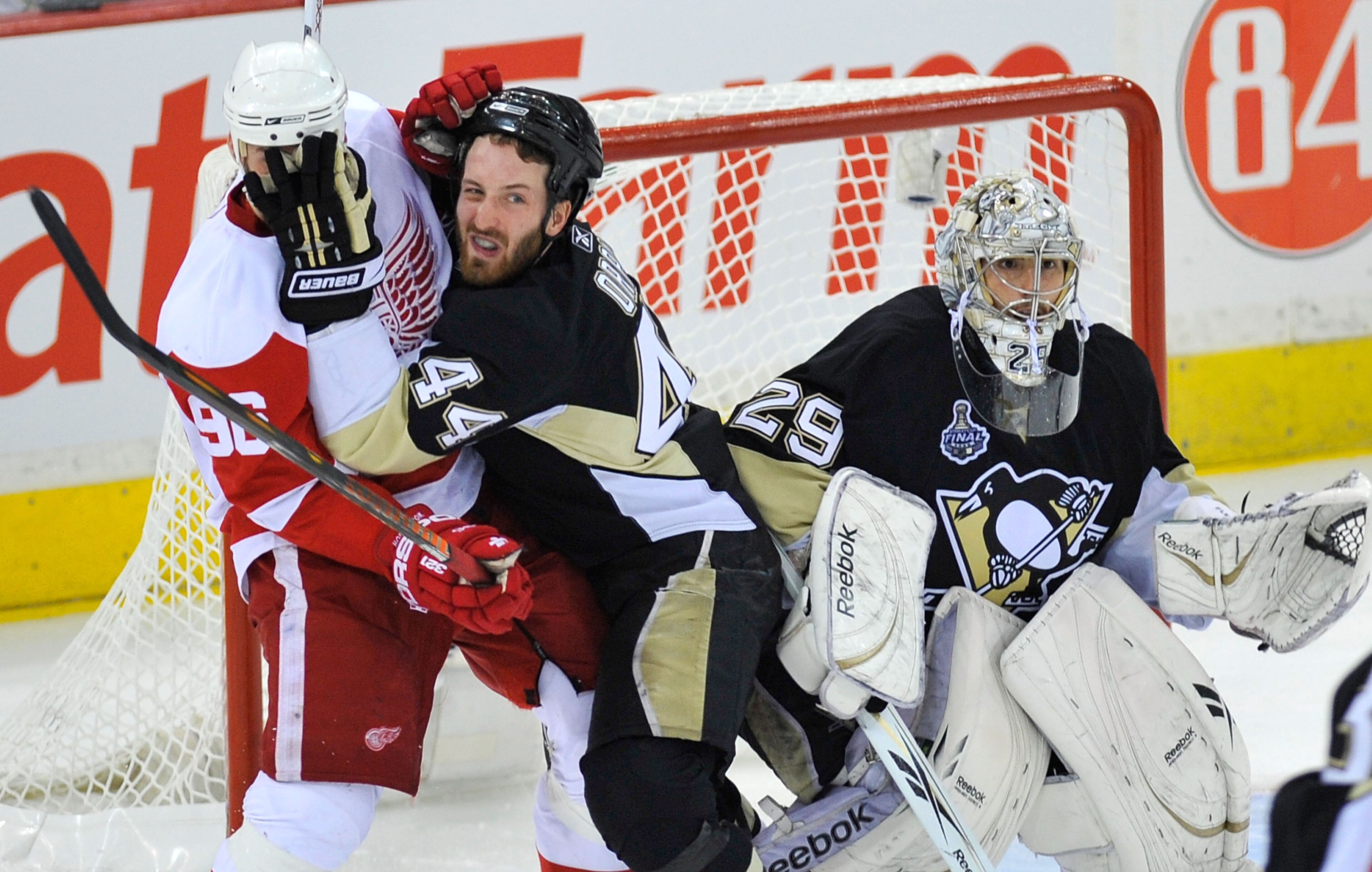 PITTSBURGH - JUNE 09:  Brooks Orpik #44 of the Pittsburgh Penguins defends goaltender Marc-Andre Fleury #29 against Tomas Holmstrom #96 of the Detroit Red Wings during Game Six of the NHL Stanley Cup Finals at the Mellon Arena on June 9, 2009 in Pittsburg