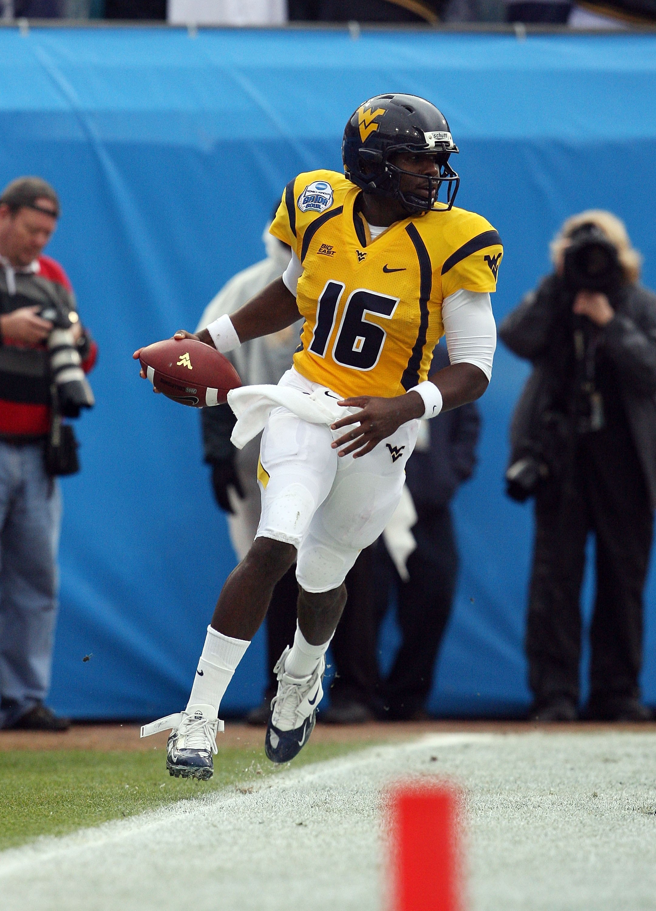 JACKSONVILLE, FL - JANUARY 01:  Quarterback Jarrett Brown #16 of the West Virginia Mountaineers celebrates his first quarter touchdown run against the Florida State Seminoles during the Konica Minolta Gator Bowl on January 1, 2010 in Jacksonville, Florida