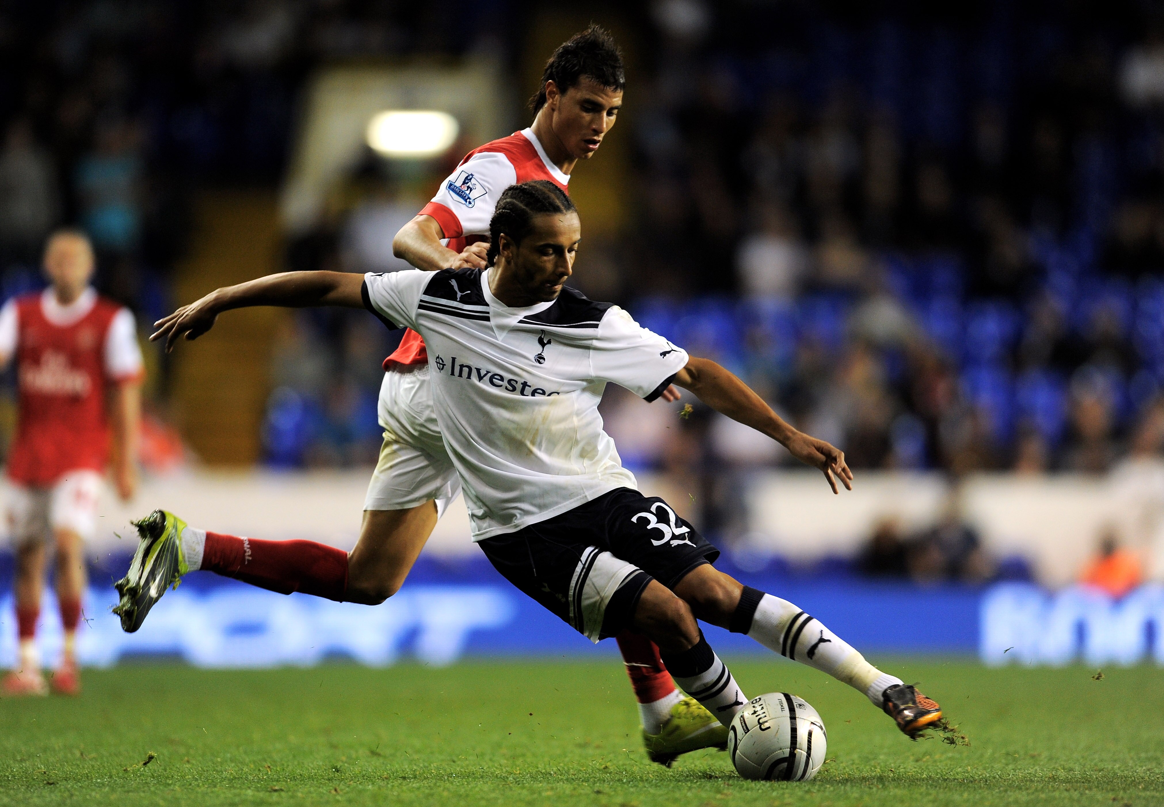 LONDON, ENGLAND - SEPTEMBER 21:  Benoit Assou-Ekotto of Spurs is challenged by Marouane Chamakh of Arsenal during the Carling Cup third round match between Tottenham Hotspur and Arsenal at White Hart Lane on September 21, 2010 in London, England.  (Photo