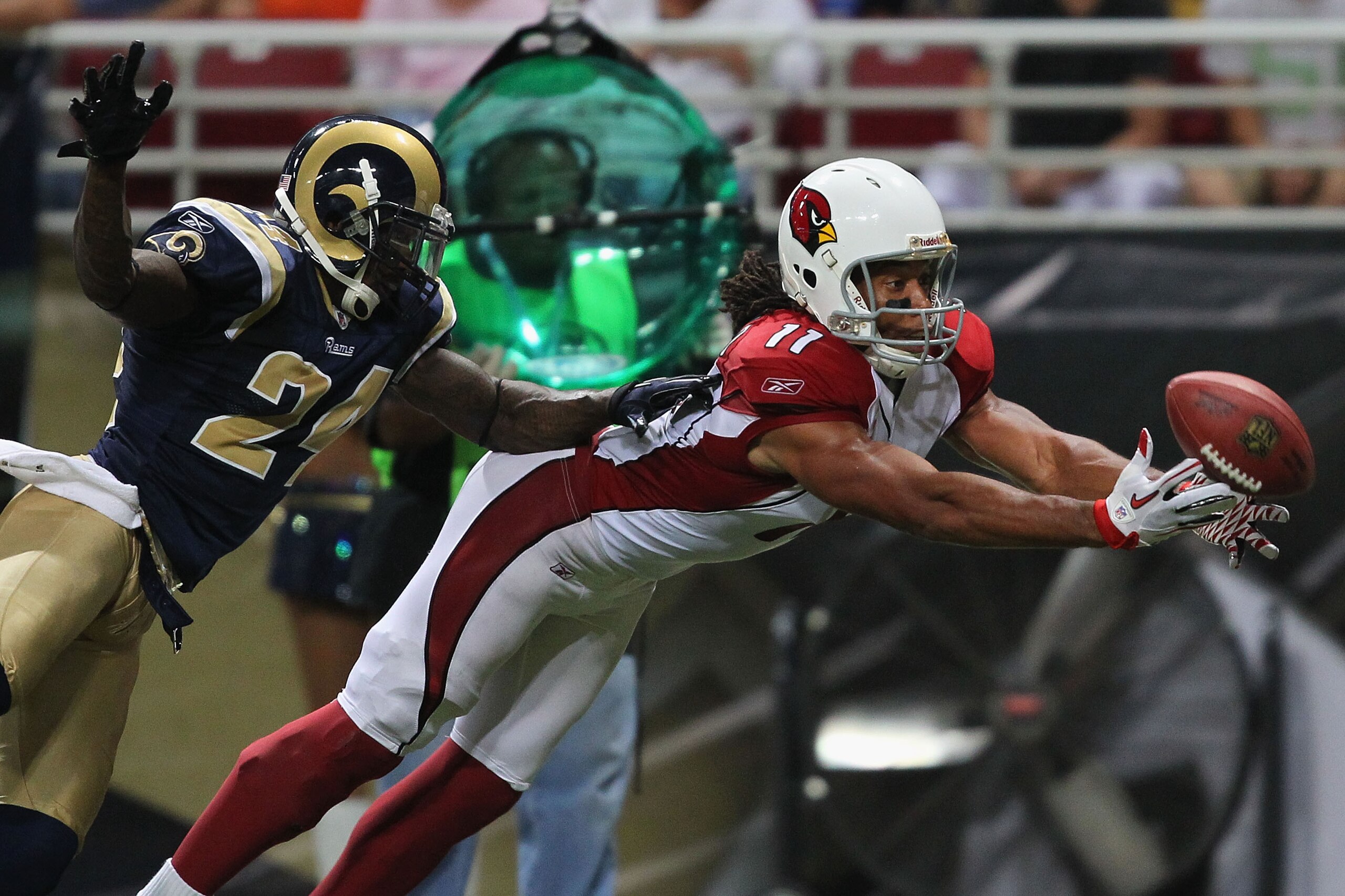 ST. LOUIS - SEPTEMBER 12: Larry Fitzgerald #11 of the Arizona Cardinals looks to haul in a touchdown pass against Ron Bartell #24 of the St. Louis Rams during the NFL season opener at the Edward Jones Dome on September 12, 2010 in St. Louis, Missouri. Th ST. LOUIS - SEPTEMBER 12: Larry Fitzgerald #11 of the Arizona Cardinals looks to haul in a touchdown pass against Ron Bartell #24 of the St. Louis Rams during the NFL season opener at the Edward Jones Dome on September 12, 2010 in St. Louis, Missouri. Th