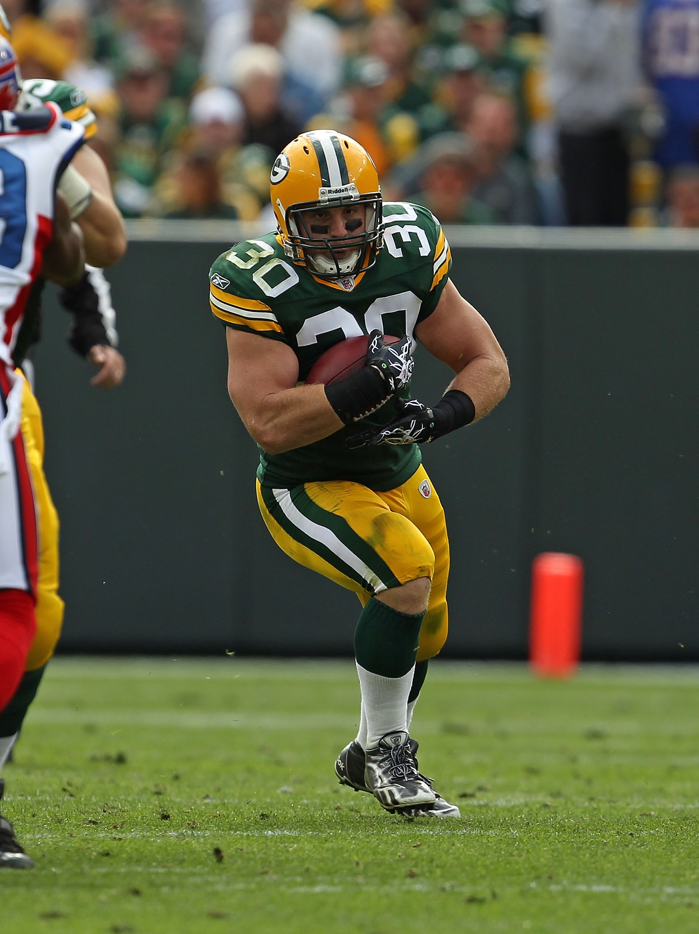 GREEN BAY, WI - SEPTEMBER 19: John Kuhn #30 of the Green Bay Packers runs against the Buffalo Bills at Lambeau Field on September 19, 2010 in Green Bay, Wisconsin. The Packers defeated the Bills 34-7.  (Photo by Jonathan Daniel/Getty Images)