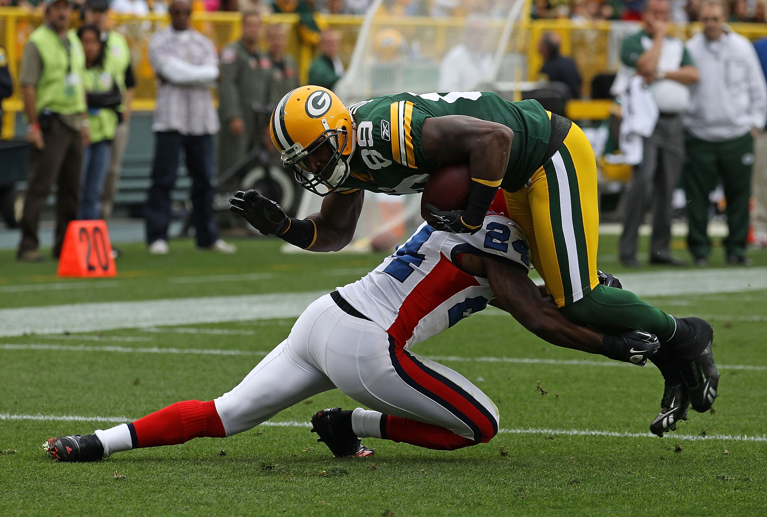 GREEN BAY, WI - SEPTEMBER 19: James Jones #89 of the Green Bay Packers is tackled by Terrence McGee #24 of the Buffalo Bills at Lambeau Field on September 19, 2010 in Green Bay, Wisconsin. The Packers defeated the Bills 34-7. (Photo by Jonathan Daniel/Get