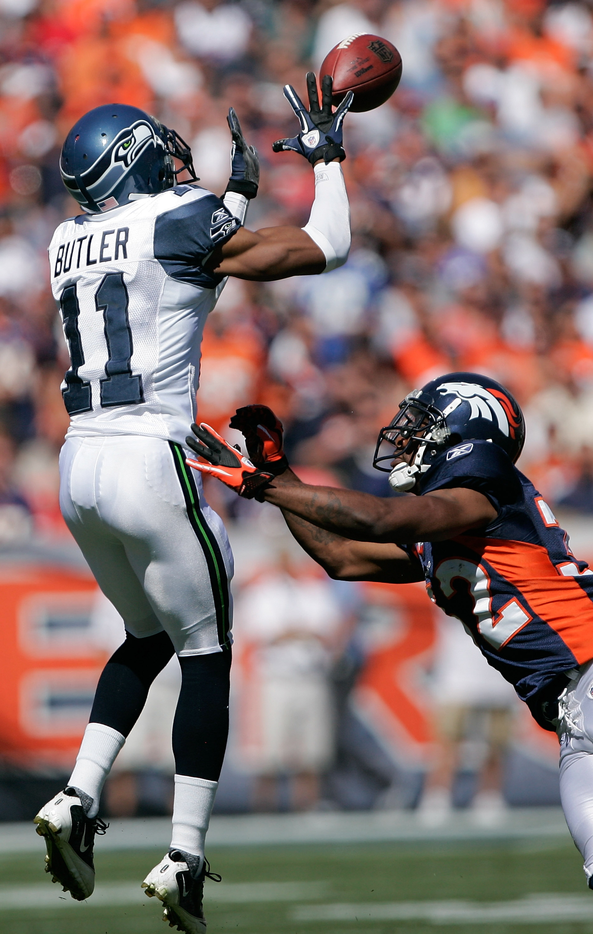 DENVER - SEPTEMBER 19:  Wide receiver Deon Butler #11 of the Seattle Seahawks makes a reception against cornerback Perrish Cox #32 of the Denver Broncos during NFL action at INVESCO Field at Mile High on September 19, 2010 in Denver, Colorado.  (Photo by