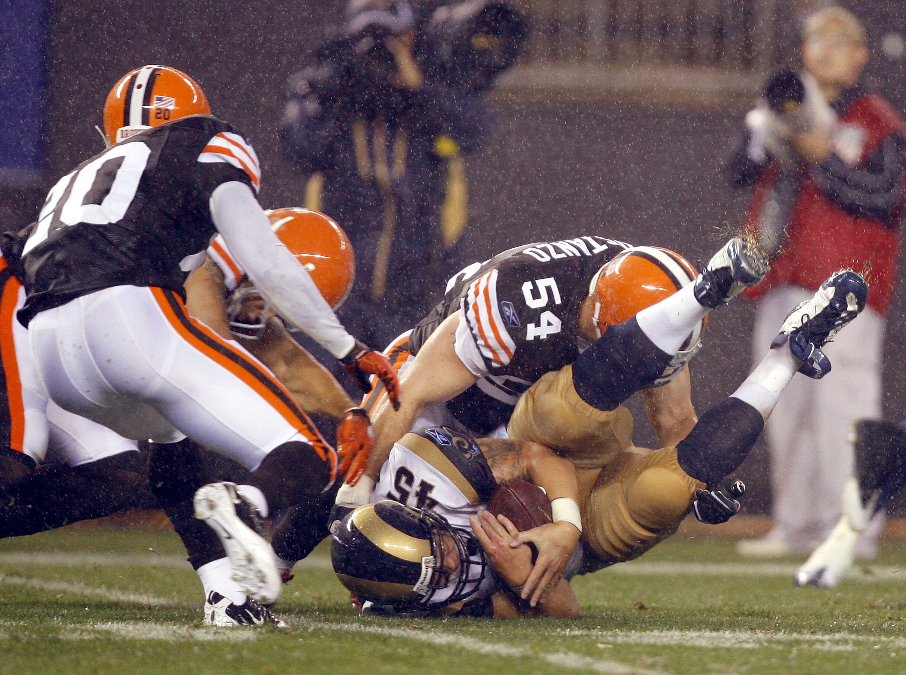 CLEVELAND - AUGUST 21:  Chris Massey #45 of the St. Louis Rams recovers a fumble as he is hit by Blake Costanzo #54 of the Cleveland Browns at Cleveland Browns Stadium on August 21, 2010 in Cleveland, Ohio.  (Photo by Matt Sullivan/Getty Images)