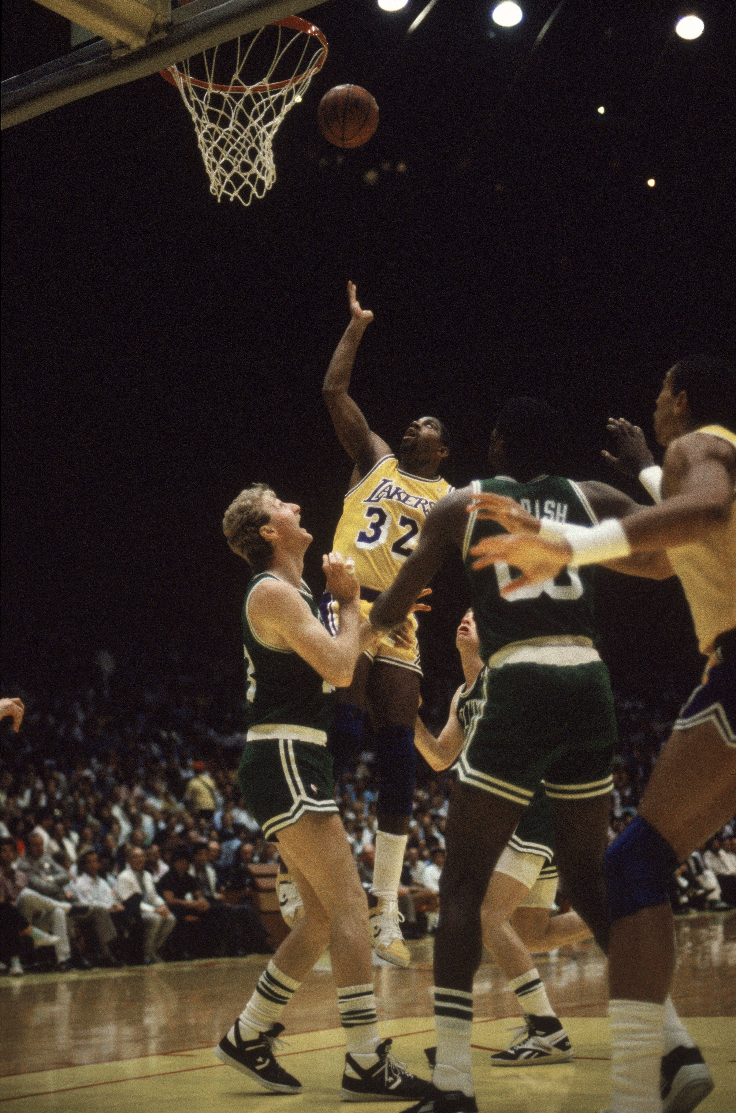 LOS ANGELES - 1987:  Magic Johnson #32 of the Los Angeles Lakers rebounds over Larry Bird #33 of the Boston Celtics during an NBA Finals game at the Great Western Forum in Los Angeles, California in 1987. (Photo by: Mike Powell/Getty Images)