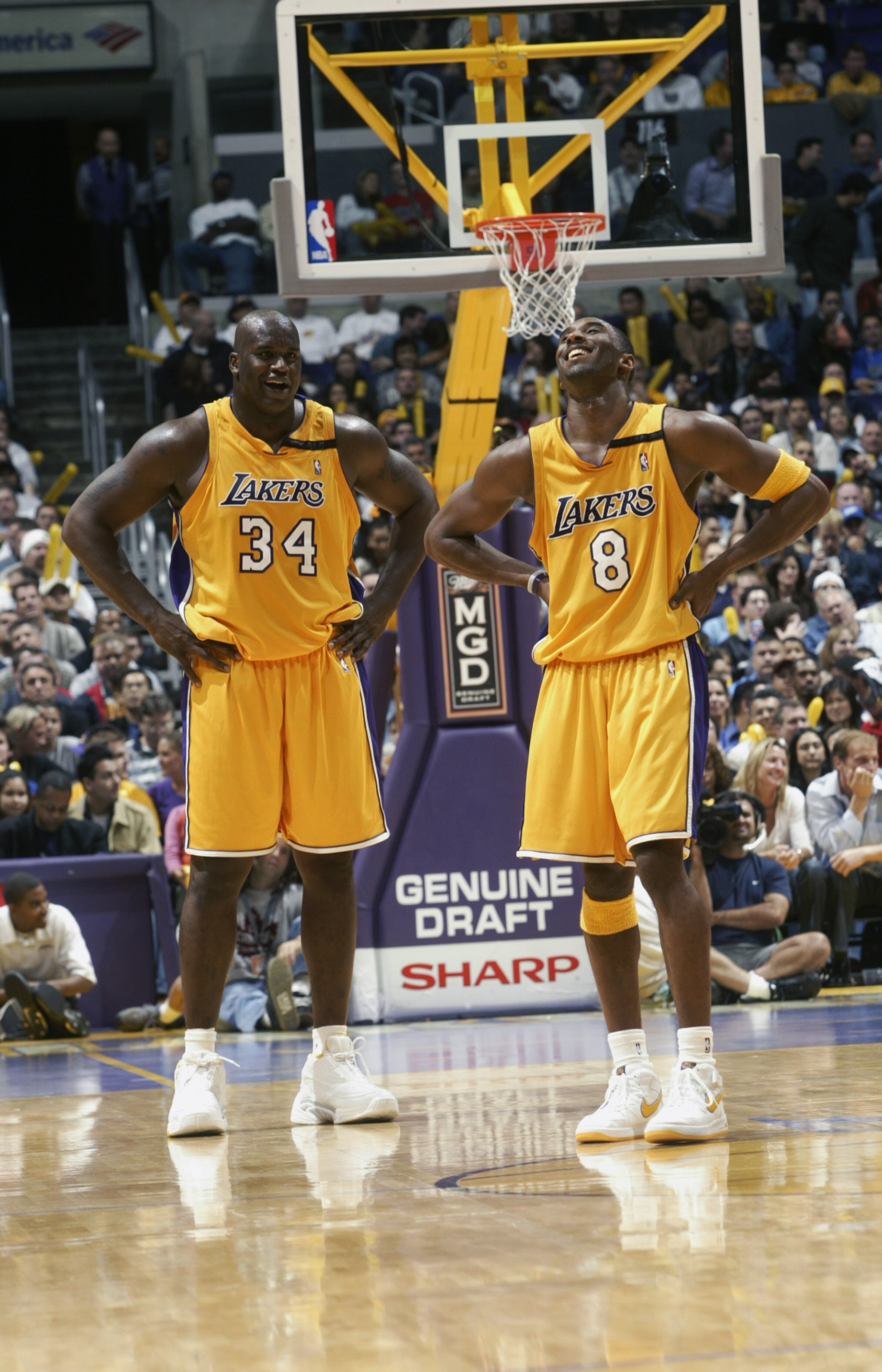 LOS ANGELES - NOVEMBER 22:  Shaquille O'Neal #34 and Kobe Bryant #8 of the Los Angeles Lakers laugh during the NBA game against the Chicago Bulls at Staples Center on November 22, 2002 in Los Angeles, California.  The Lakers won 86-73.  NOTE TO USER: User