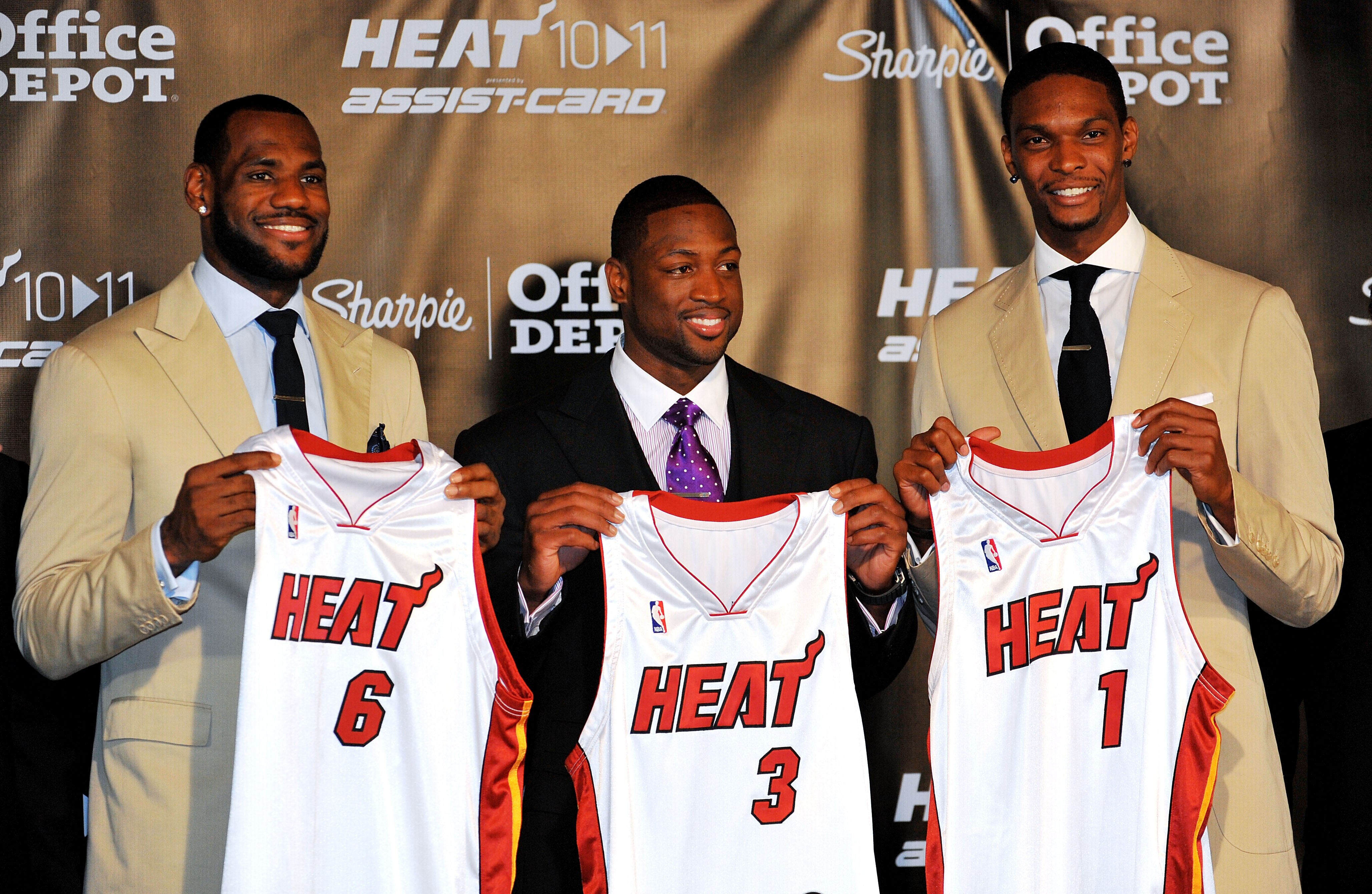 MIAMI - JULY 09:  LeBron James #6, Dwyane Wade #3 and Chris Bosh #1 of the Miami Heat show off their new game jerseys before a press conference after a welcome party at American Airlines Arena on July 9, 2010 in Miami, Florida.  (Photo by Doug Benc/Getty