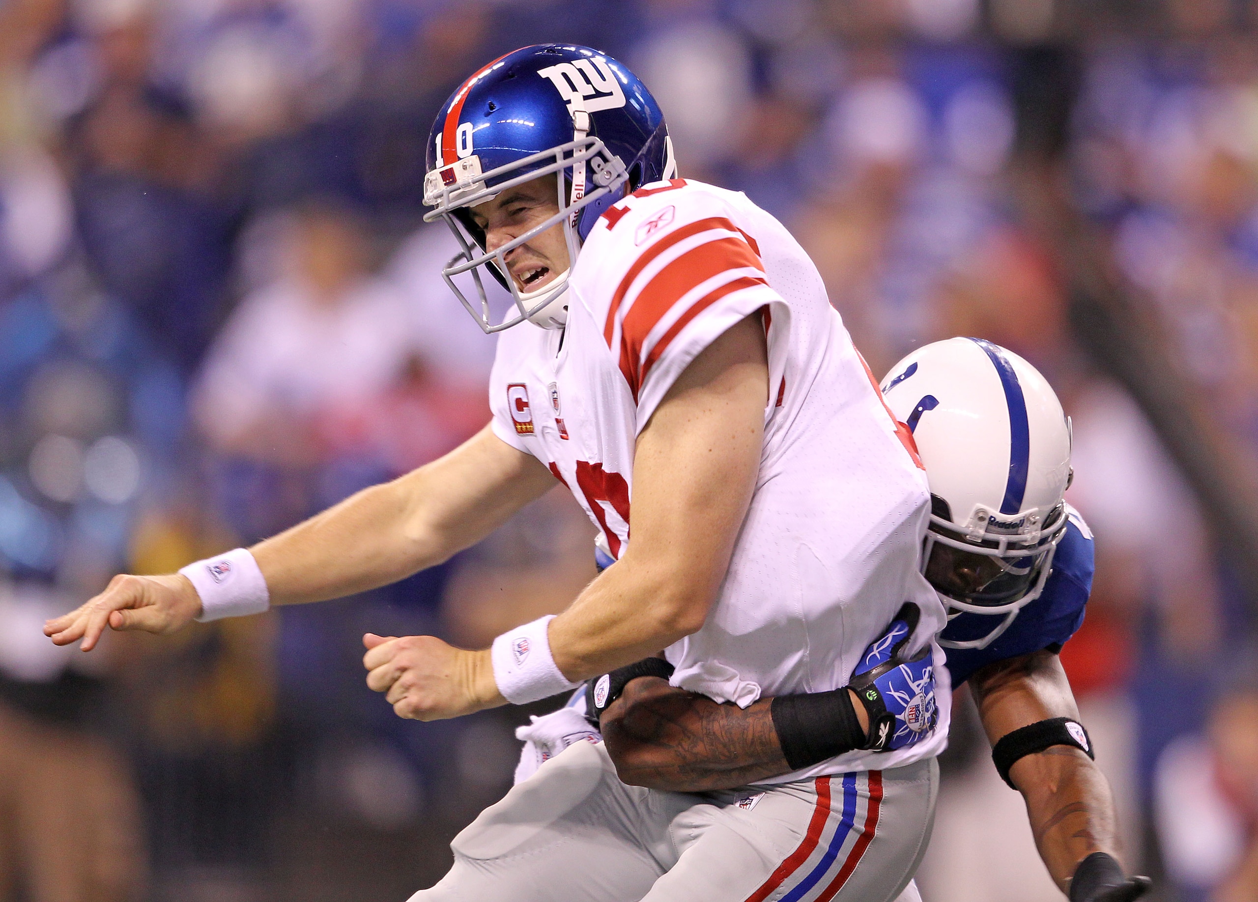 INDIANAPOLIS - SEPTEMBER 19:  Eli Manning #10 of the New York Giants is hit by Antoine Bethea #41 of the Indianapolis Colts during the Colts 38-14 win at Lucas Oil Stadium on September 19, 2010 in Indianapolis, Indiana.  (Photo by Andy Lyons/Getty Images)