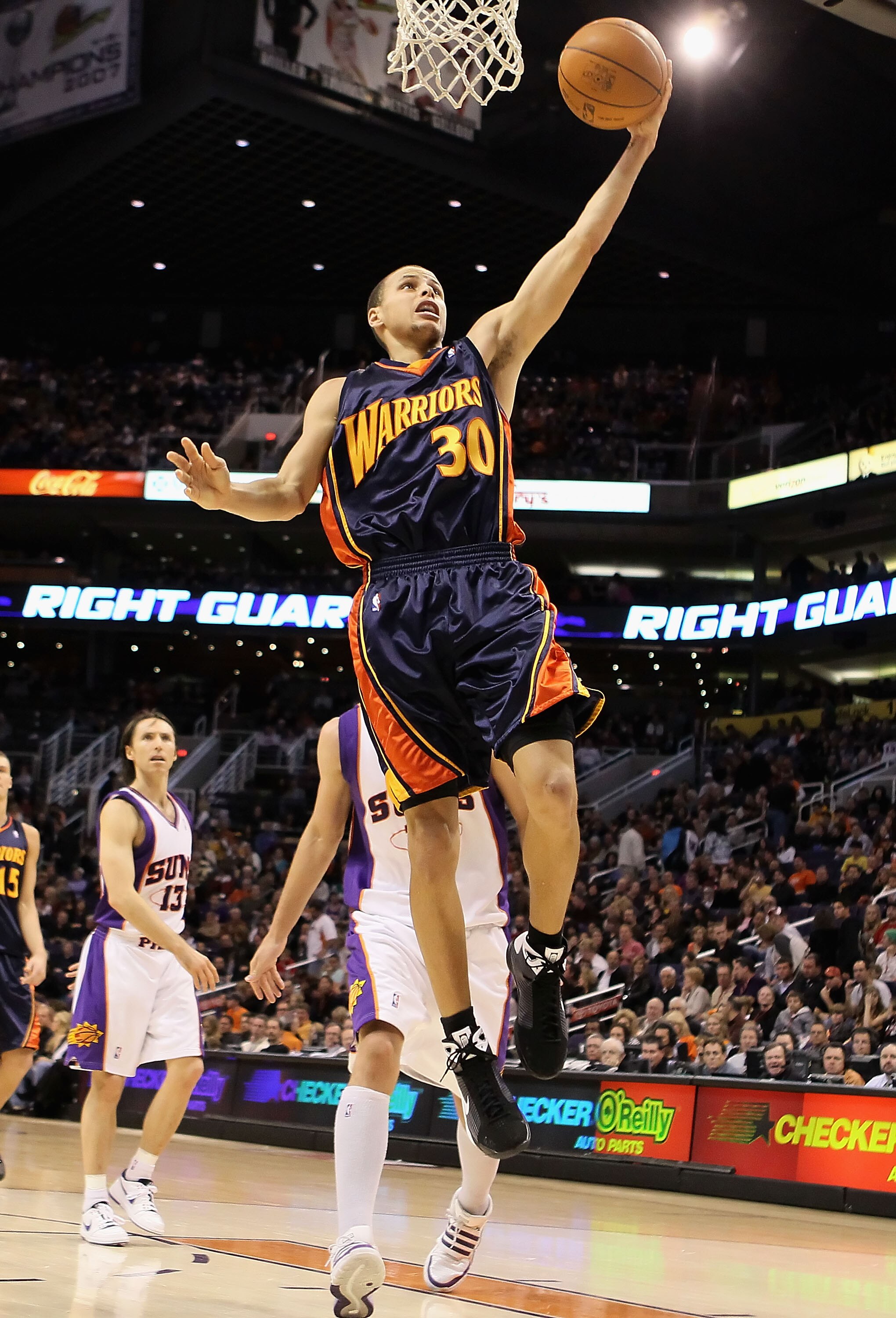 PHOENIX - JANUARY 23:  Stephen Curry #30 of the Golden State Warriors lays up a shot against the Phoenix Suns during the NBA game at US Airways Center on January 23, 2010 in Phoenix, Arizona. NOTE TO USER: User expressly acknowledges and agrees that, by d