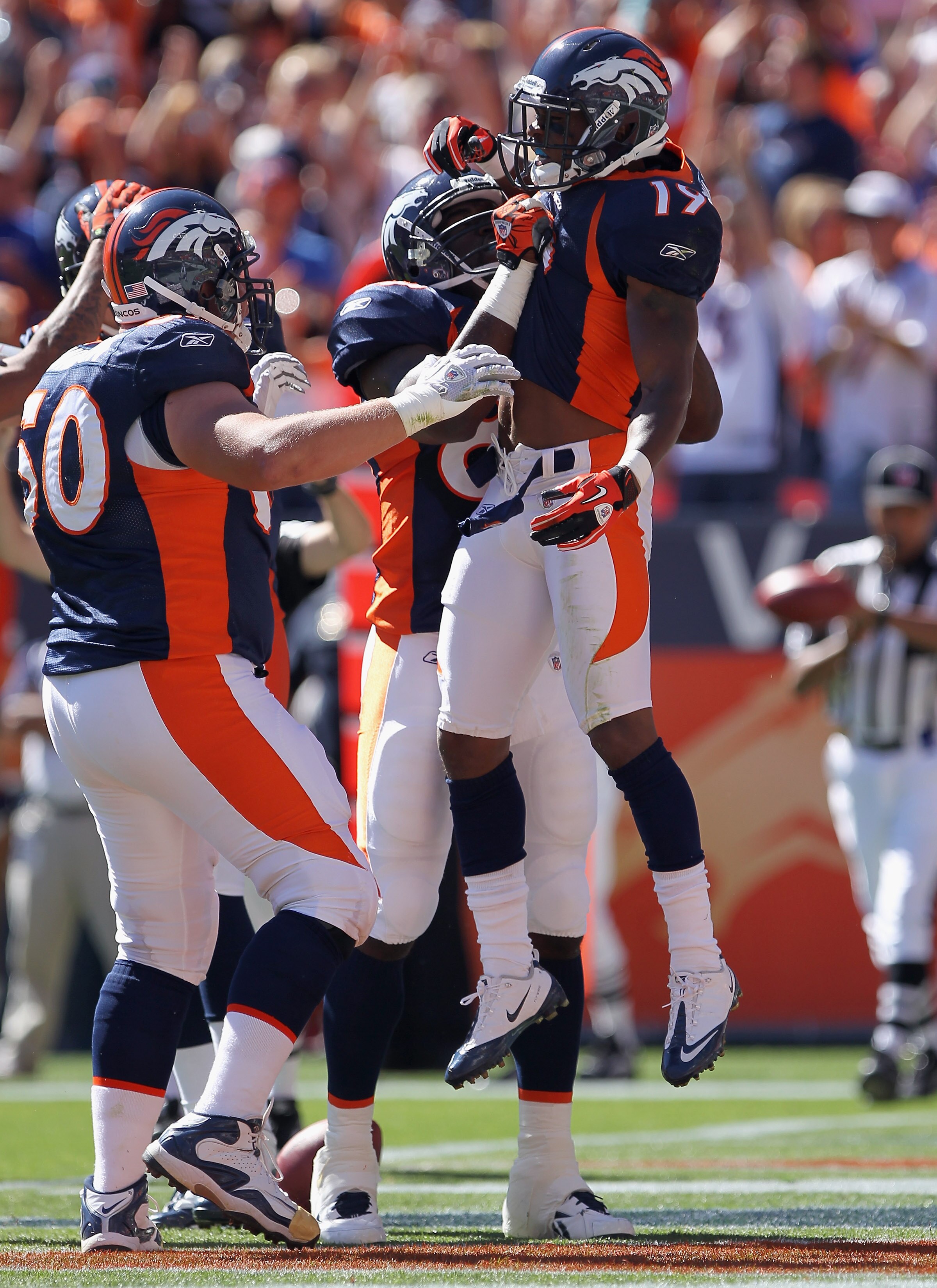 DENVER - SEPTEMBER 19:  Wide receiver Eddie Royal #19 of the Denver Broncos celebates his first quarter touchdown with his teammates as they face the Seattle Seahawks at INVESCO Field at Mile High on September 19, 2010 in Denver, Colorado. The Broncos def
