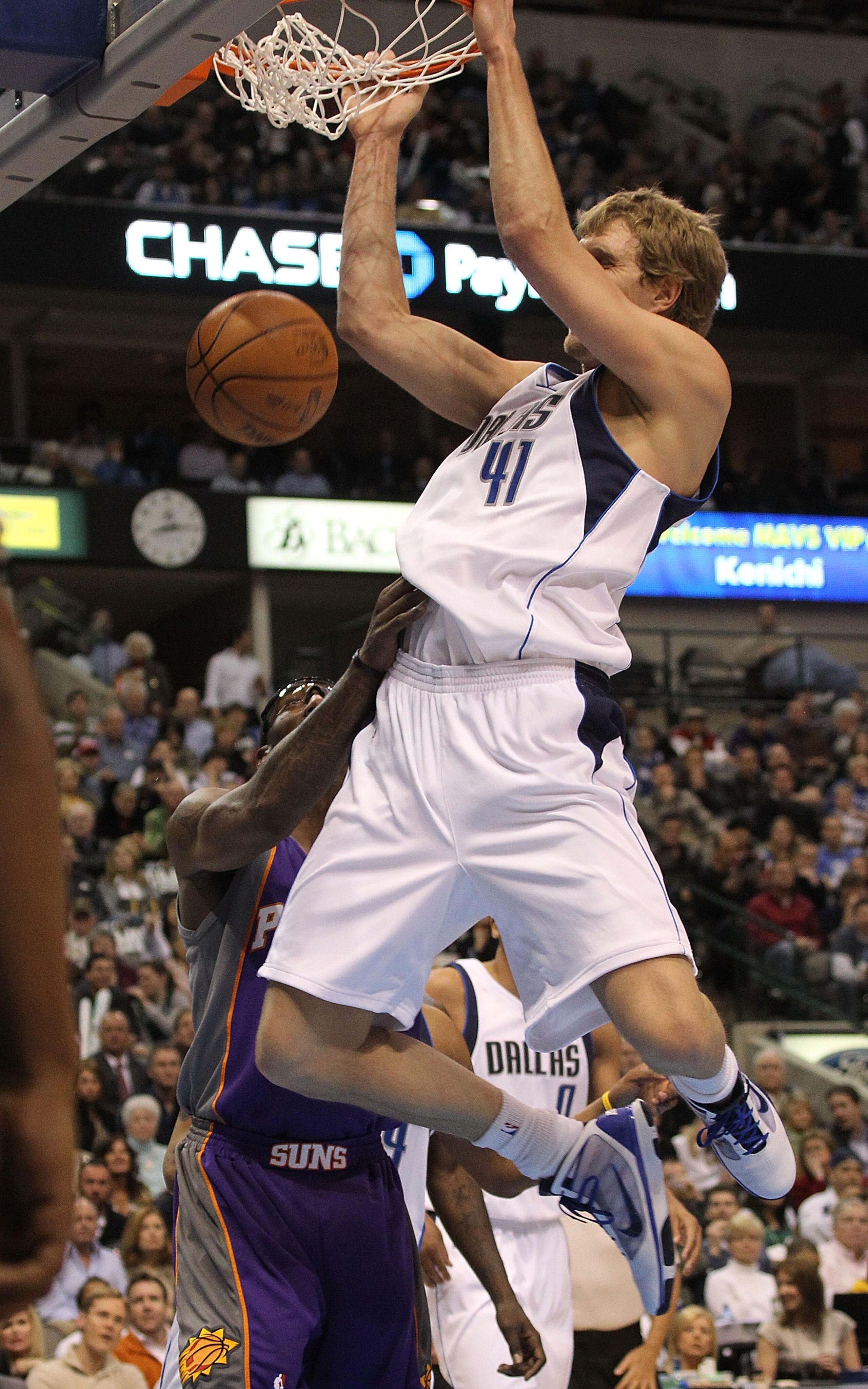 DALLAS - FEBRUARY 17:  Forward Dirk Nowitzki #41 of the Dallas Mavericks slams the ball against Amar'e Stoudemire #1 of the Phoenix Suns on February 17, 2010 at American Airlines Center in Dallas, Texas.  NOTE TO USER: User expressly acknowledges and agre