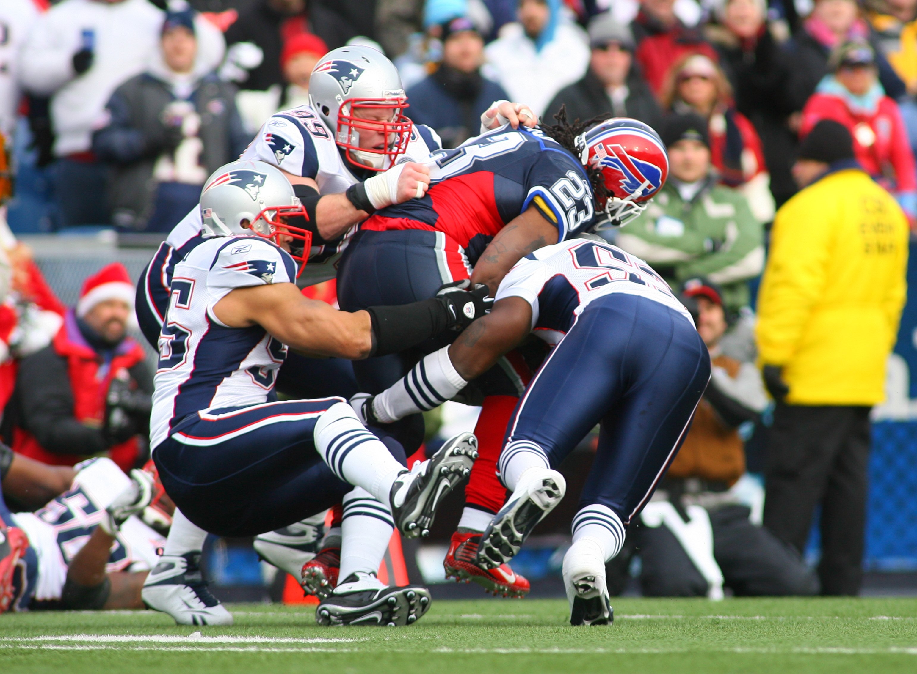 ORCHARD PARK, NY - DECEMBER 20: Marshawn Lynch #23 of the Buffalo Bills is taken down by the New England Patriots defense during the game at Ralph Wilson Stadium on December 20, 2009 in Orchard Park, New York. (Photo by: Rick Stewart/Getty Images)