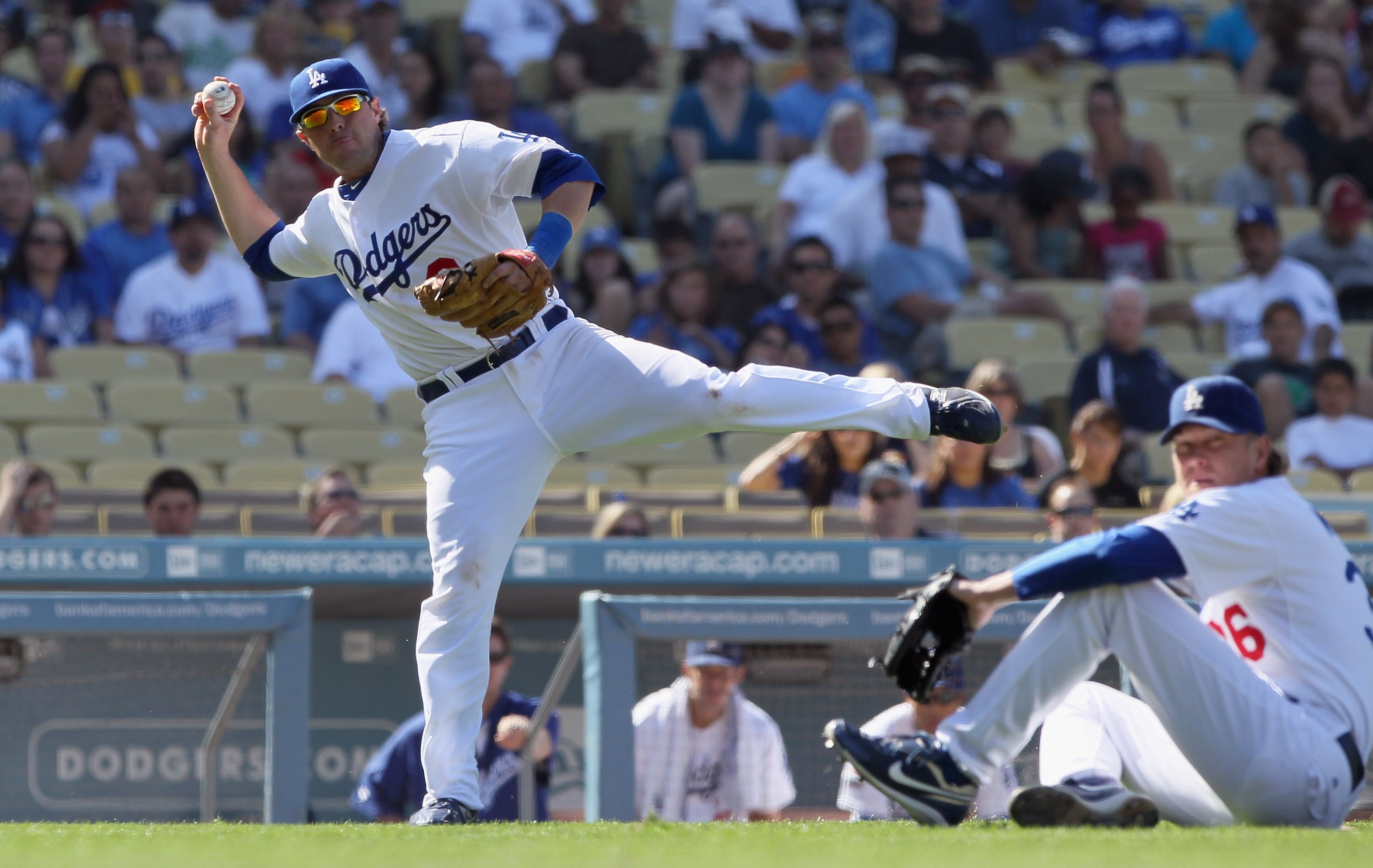 LOS ANGELES, CA - SEPTEMBER 18:  Third baseman Russ Mitchell #9 of the Los Angeles Dodgers commits a throwing error allowing Miguel Olivo (not pictured) of the Colorado Rockies to score in the eighth inning at Dodger Stadium on September 18, 2010 in Los A