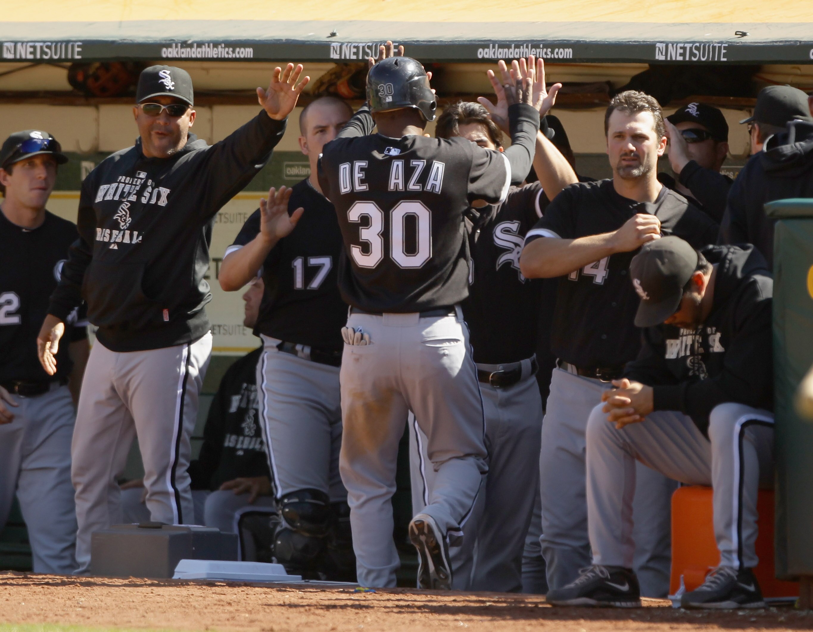 OAKLAND, CA - SEPTEMBER 22: Alejandro De Aza #30 of the Chicago White Sox is congratulated by teammates after he scored on a single byMark Kotsay #7 in the ninth inning to tie the game 3-3 against the Oakland Athletics at the Oakland-Alameda County Colise