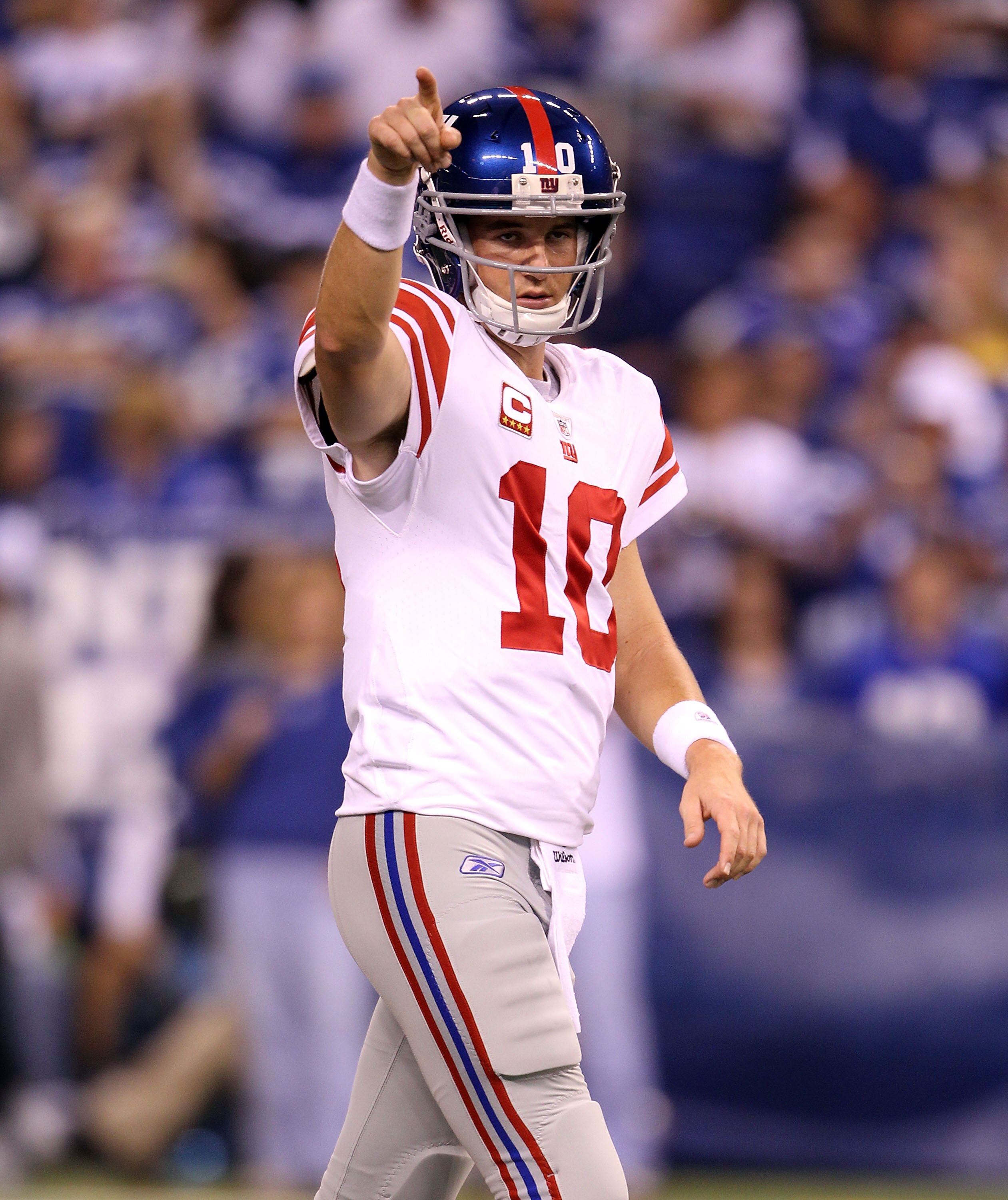 INDIANAPOLIS - SEPTEMBER 19:  Eli Manning #10  of the New York Giants gives instructions to his team  in warmups before the NFL game against the Indianapolis Colts at Lucas Oil Stadium on September 19, 2010 in Indianapolis, Indiana.  (Photo by Andy Lyons/
