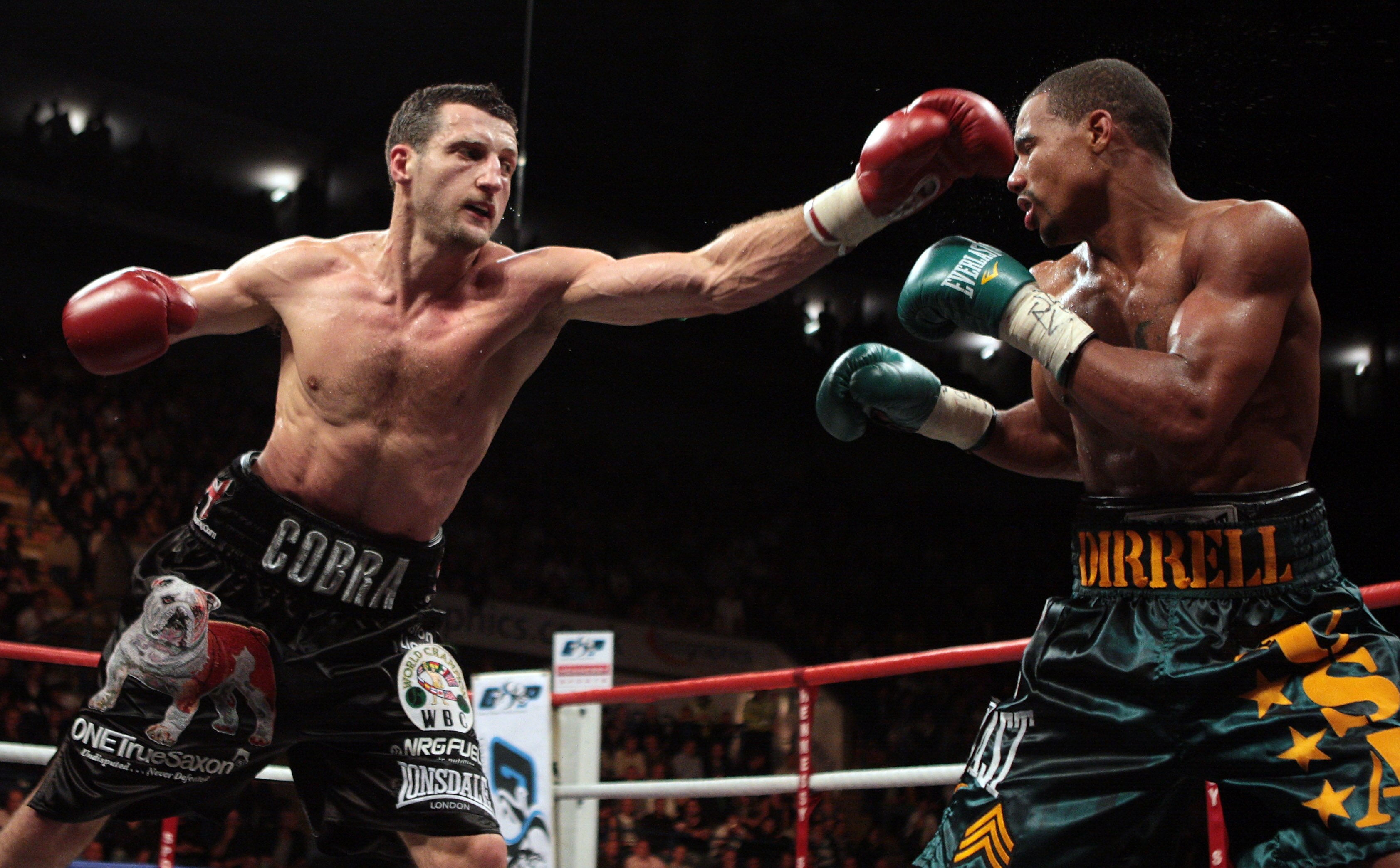 NOTTINGHAM, ENGLAND - OCTOBER 17:  Carl Froch (L) connects with a left jab as he retains his title against Andre Dirrell during their WBC Super Middleweight fight on October 17, 2009 at Trent FM Arena in Nottingham, England.  (Photo by John Gichigi/Getty