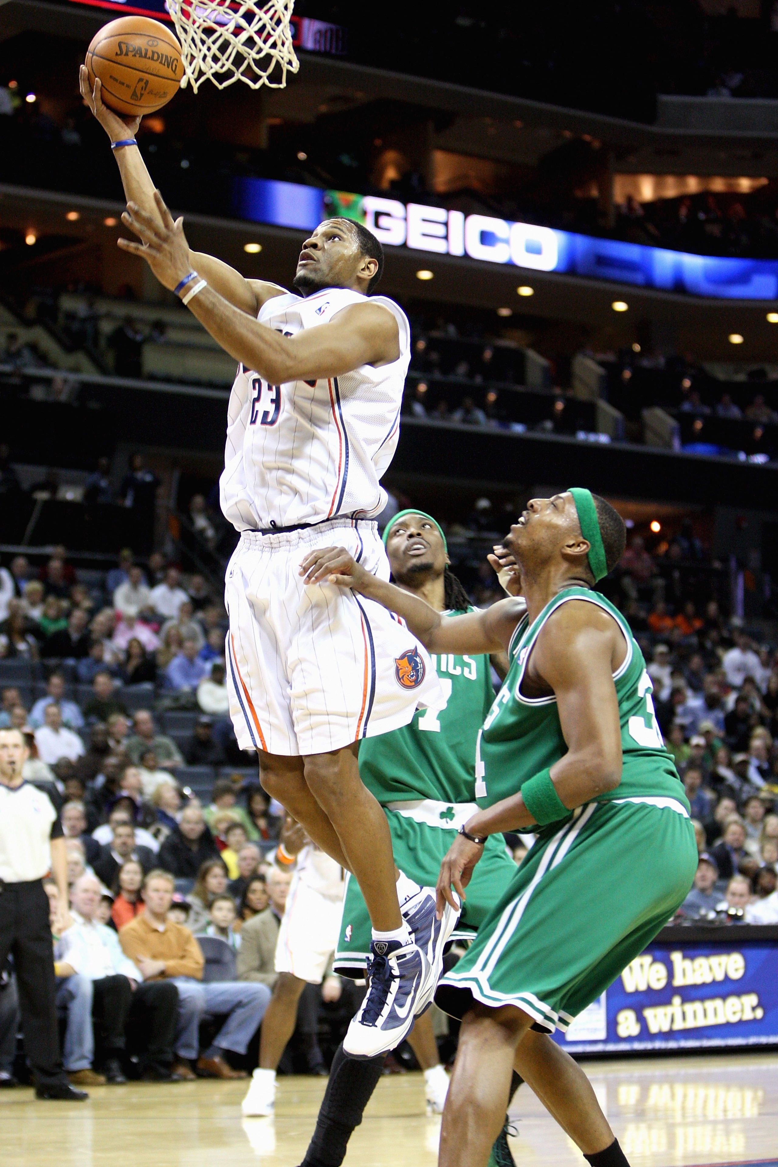 CHARLOTTE, NC - DECEMBER 1:  Stephen Graham #23 of the Charlotte Bobcats lays the ball up over Marquis Daniels #7 and Paul Pierce #34 of the Boston Celtics during the game on December 1, 2009 at Time Warner Cable Arena in Charlotte, North Carolina.  The C