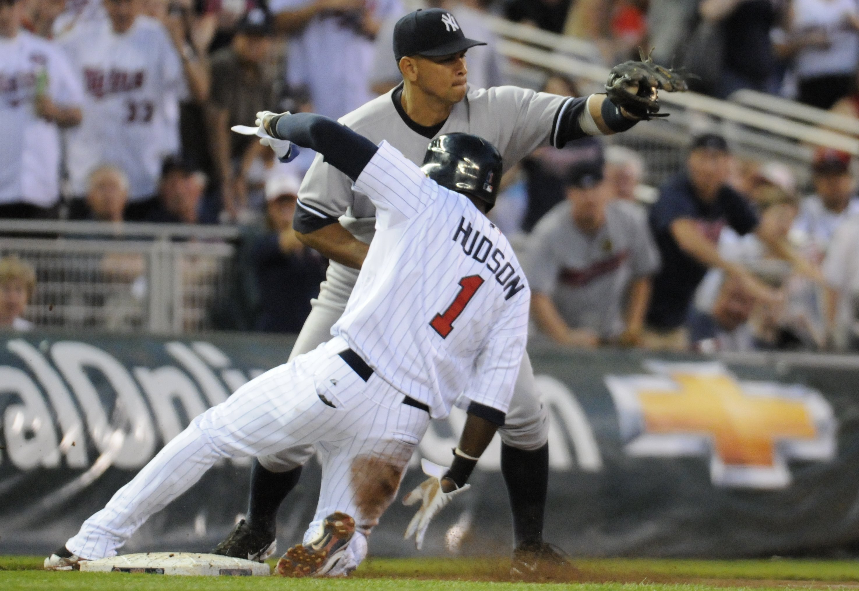 MINNEAPOLIS, MN - MAY 27: Orlando Hudson #1 of the Minnesota Twins slides into third base safely with a triple as Alex Rodriguez #13 of the New York Yankees catches the throw in the fifth inning of the game on May 27, 2010 at Target Field in Minneapolis,