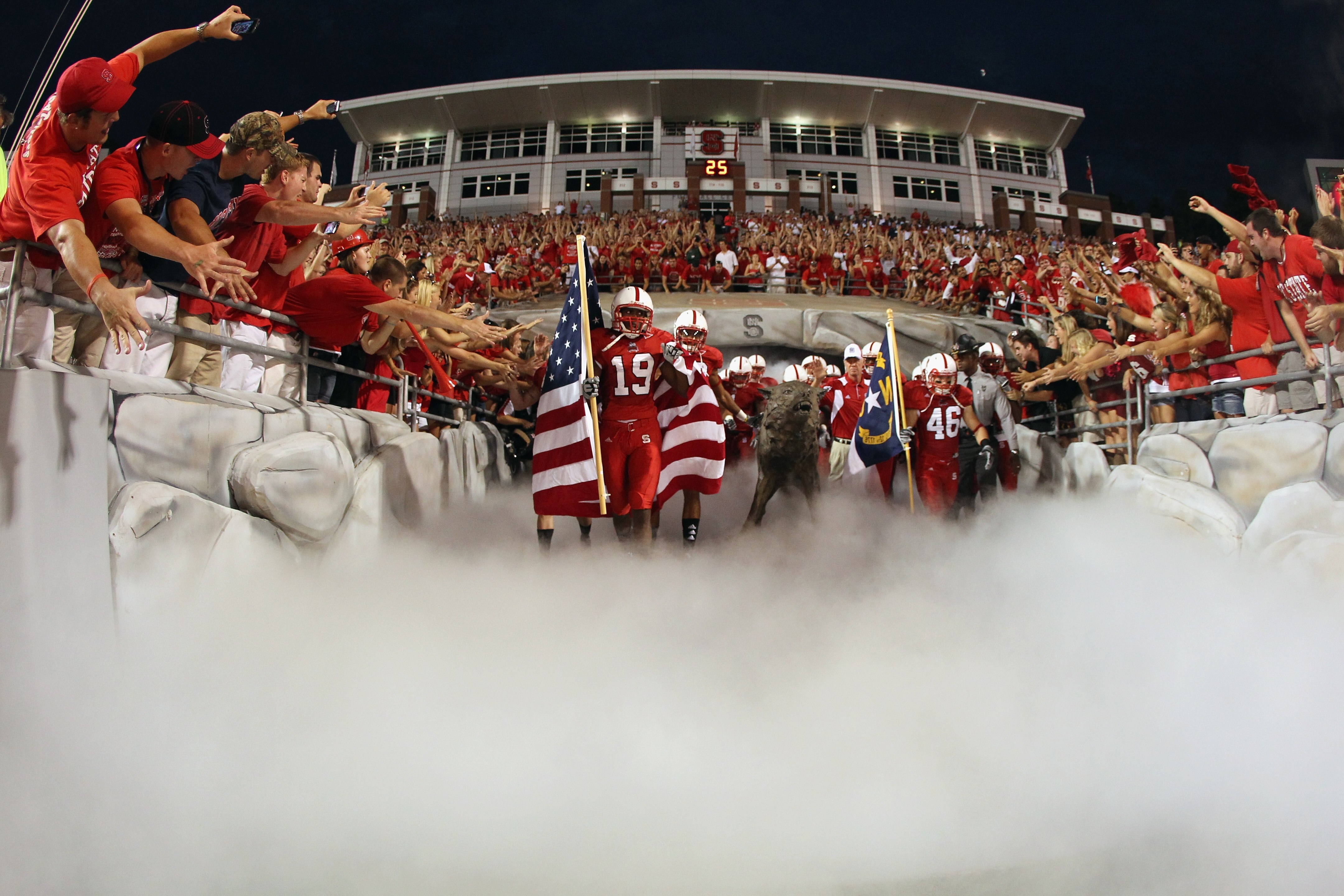 RALEIGH, NC - SEPTEMBER 16:  Jesse Riley #19 of the North Carolina State Wolfpack runs onto the field with teammates before their game against the Cincinnati Bearcats at Carter-Finley Stadium on September 16, 2010 in Raleigh, North Carolina.  (Photo by St