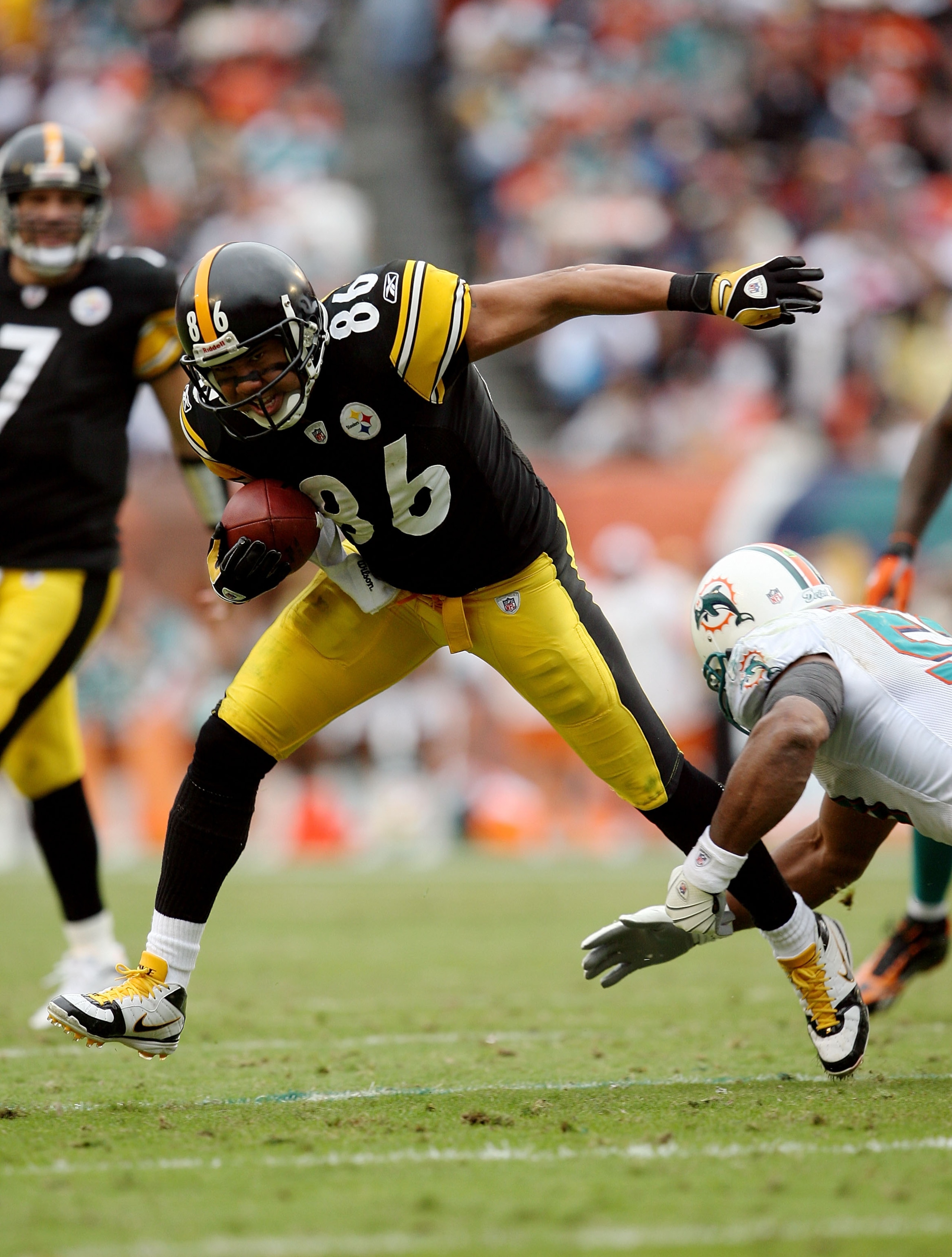 MIAMI - JANUARY 03:  Wide receiver Hines Ward #86 of the Pittsburgh Steelers avoids a tackle attempt by Akin Ayodele #51 of the Miami Dolphins at Land Shark Stadium on January 3, 2010 in Miami, Florida. The Steelers defeated the Dolphins 30-24.  (Photo by