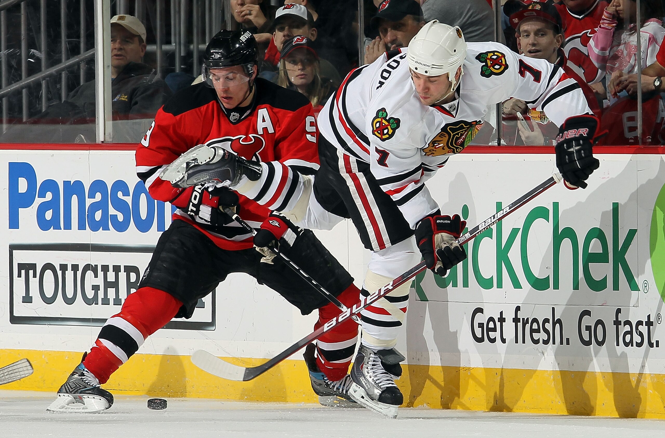 NEWARK, NJ - APRIL 02:  Brent Seabrook #7 of the Chicago Blackhawks plays the puck against Zach Parise #9 of the New Jersey Devils at the Prudential Center on April 2, 2010 in Newark, New Jersey.  (Photo by Jim McIsaac/Getty Images)