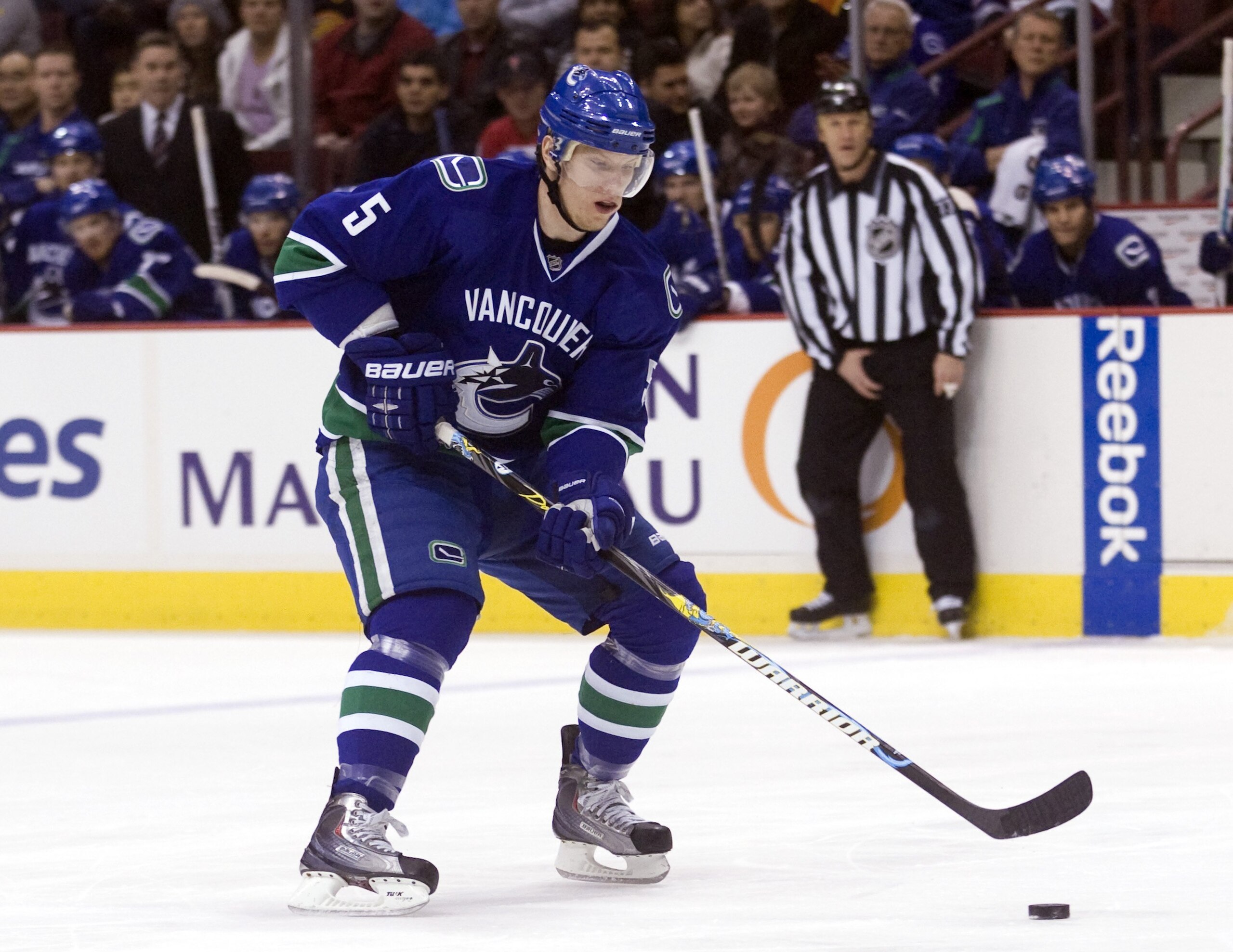 VANCOUVER, CANADA - DECEMBER 22: Christian Ehrhoff #5 of the Vancouver Canucks skates up ice with the puck during NHL action against the Nashville Predators on December 22, 2009 at General Motors Place in Vancouver, British Columbia, Canada.  (Photo by Ri
