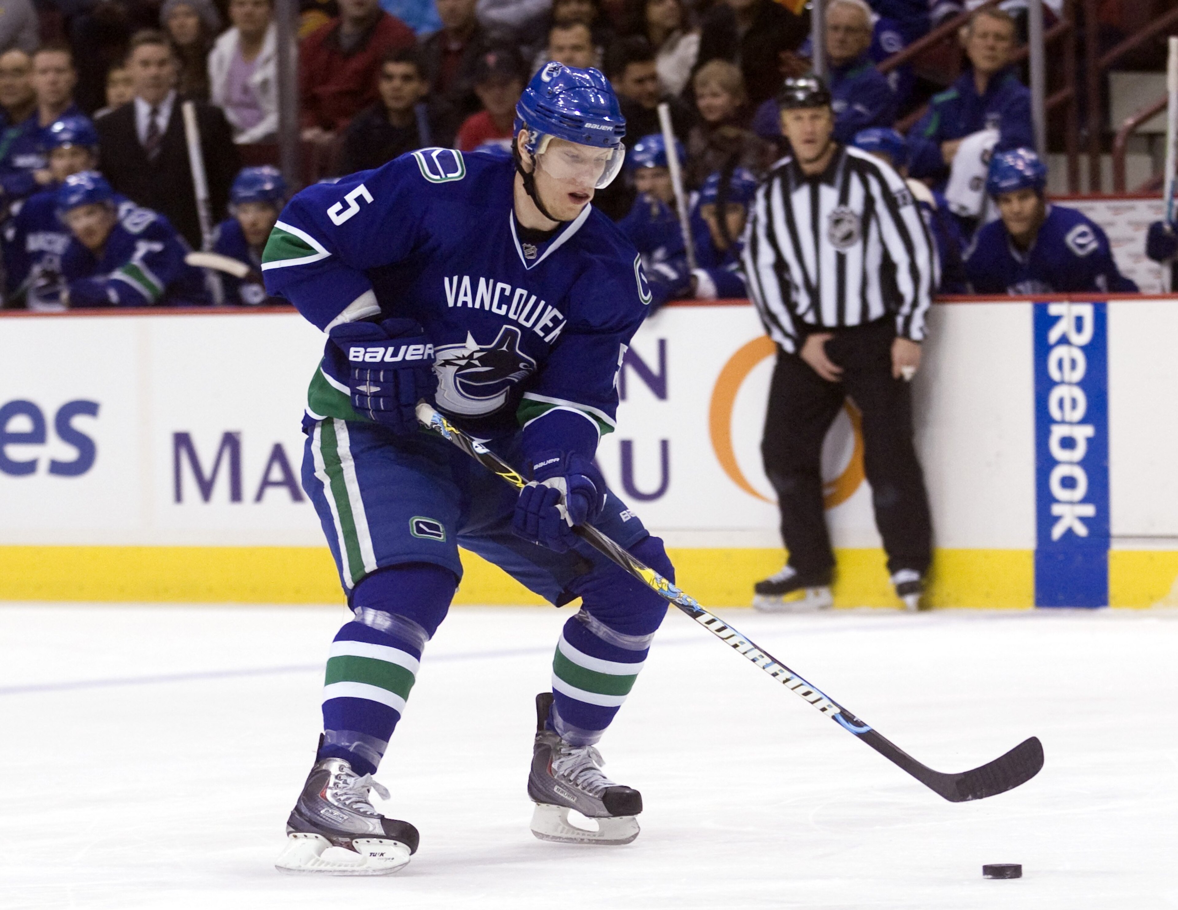 VANCOUVER, CANADA - DECEMBER 22: Christian Ehrhoff #5 of the Vancouver Canucks skates up ice with the puck during NHL action against the Nashville Predators on December 22, 2009 at General Motors Place in Vancouver, British Columbia, Canada.  (Photo by Ri