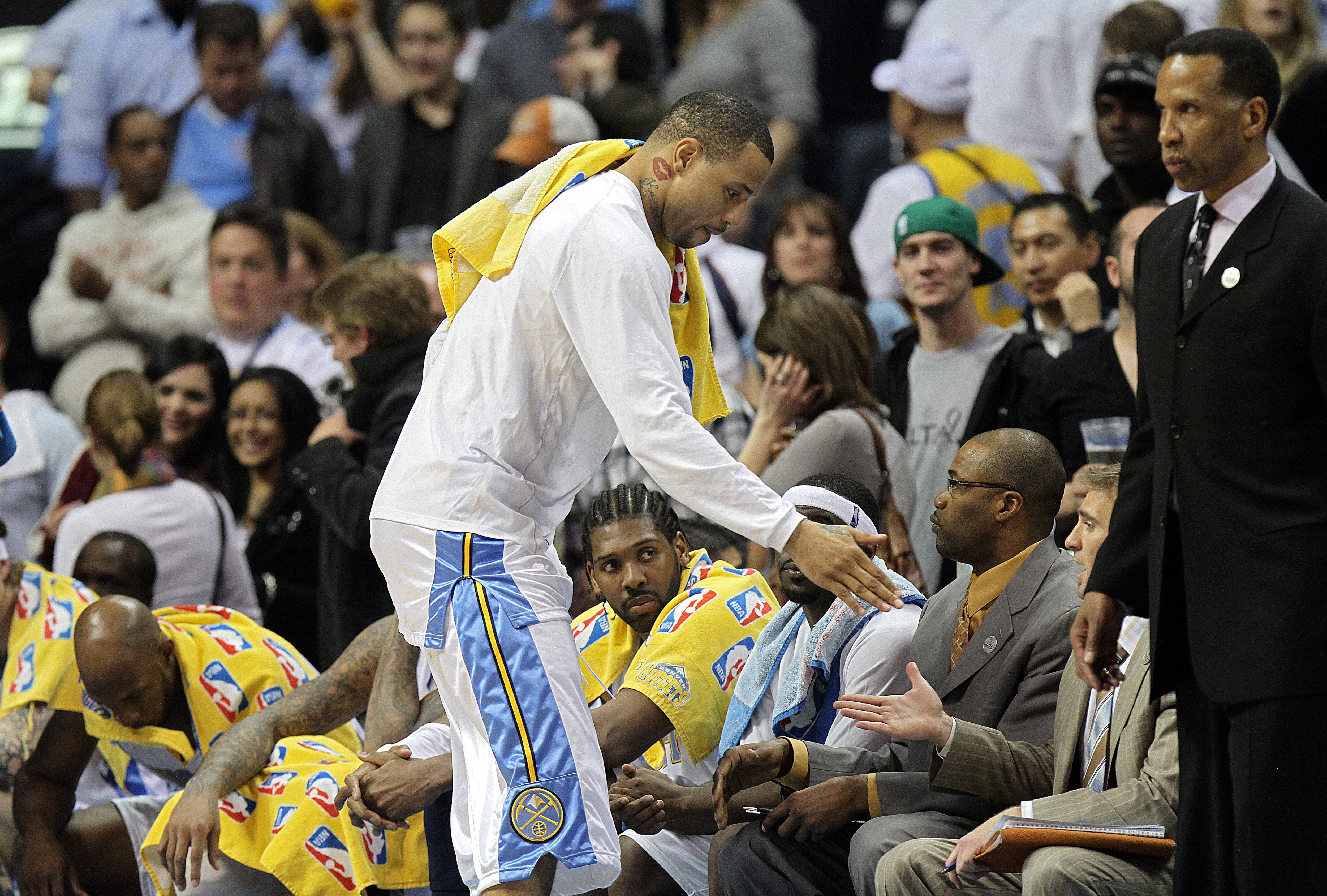 DENVER, CO - APRIL 17: Kenyon Martin #4 of the Denver Nuggets high fives teammates and coaches in the closing moments of a win over the Utah Jazz during the second half of Game One of the Western Conference Quarterfinals of the 2010 NBA Playoffs at the Pe