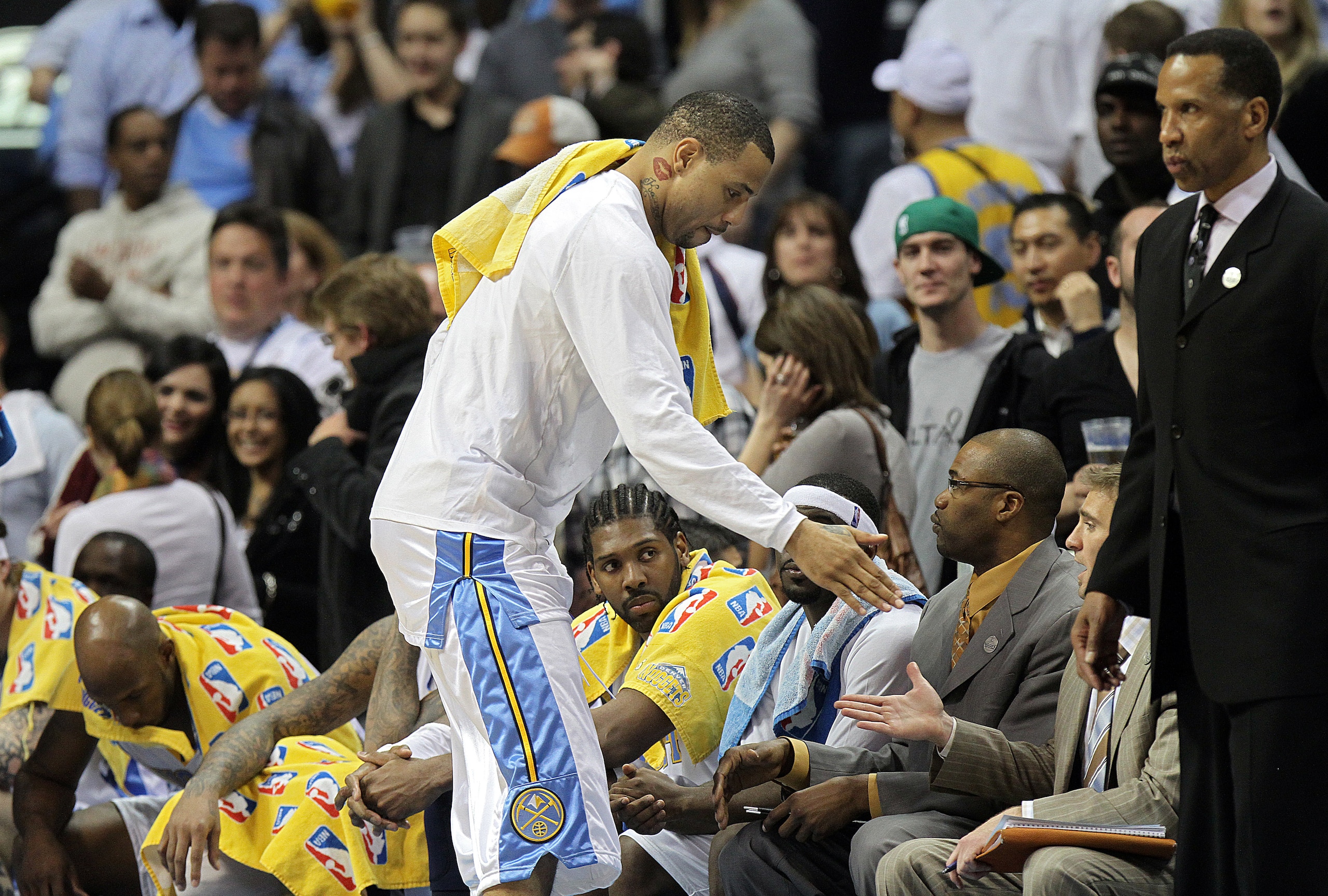 DENVER, CO - APRIL 17: Kenyon Martin #4 of the Denver Nuggets high fives teammates and coaches in the closing moments of a win over the Utah Jazz during the second half of Game One of the Western Conference Quarterfinals of the 2010 NBA Playoffs at the Pe