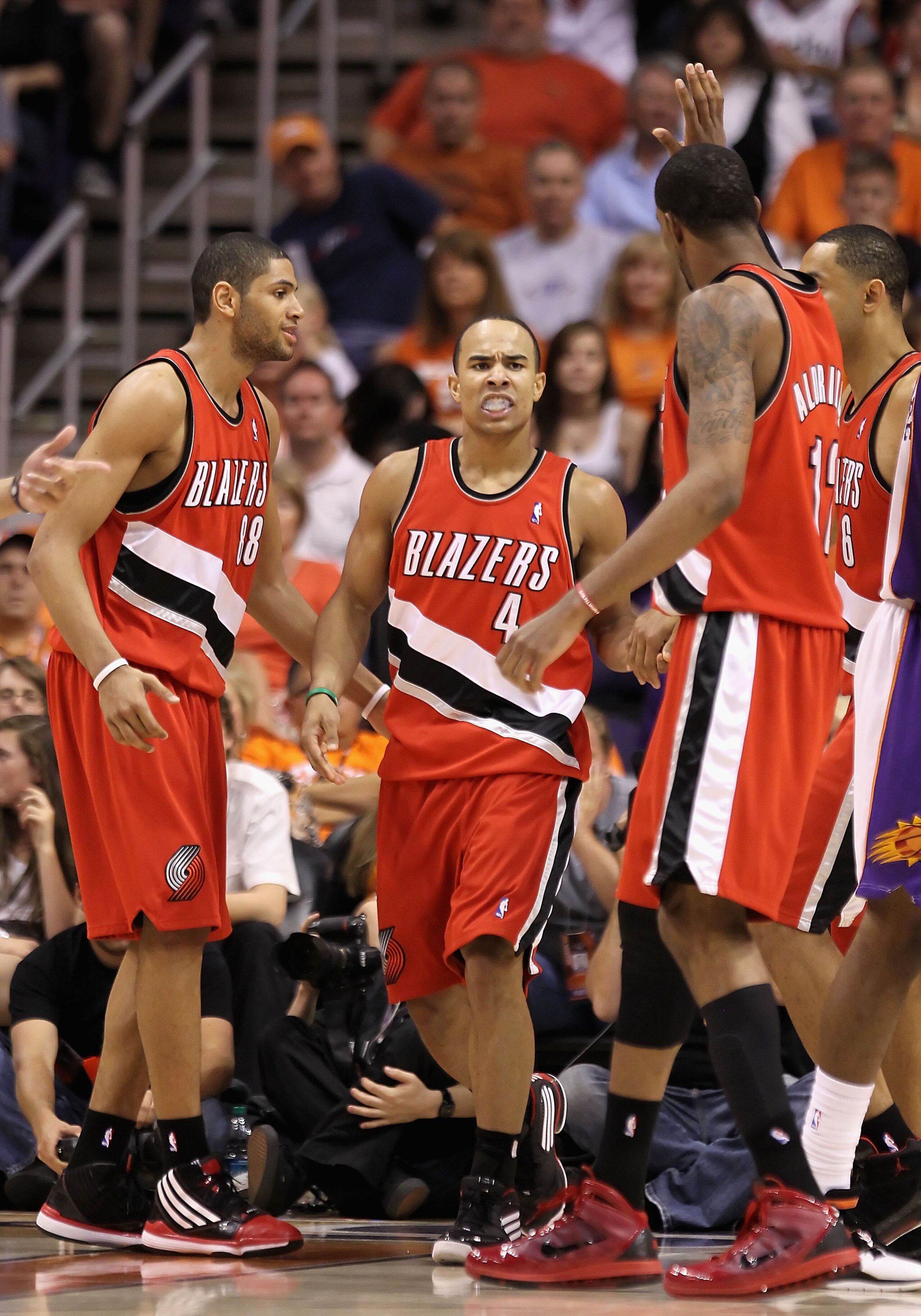 PHOENIX - APRIL 18:  Jerryd Bayless #4 of the Portland Trail Blazers is congratulated by teammates Nicolas Batum #88 and LaMarcus Aldridge #12 after Bayless scored against the Phoenix Suns during Game One of the Western Conference Quarterfinals of the 201