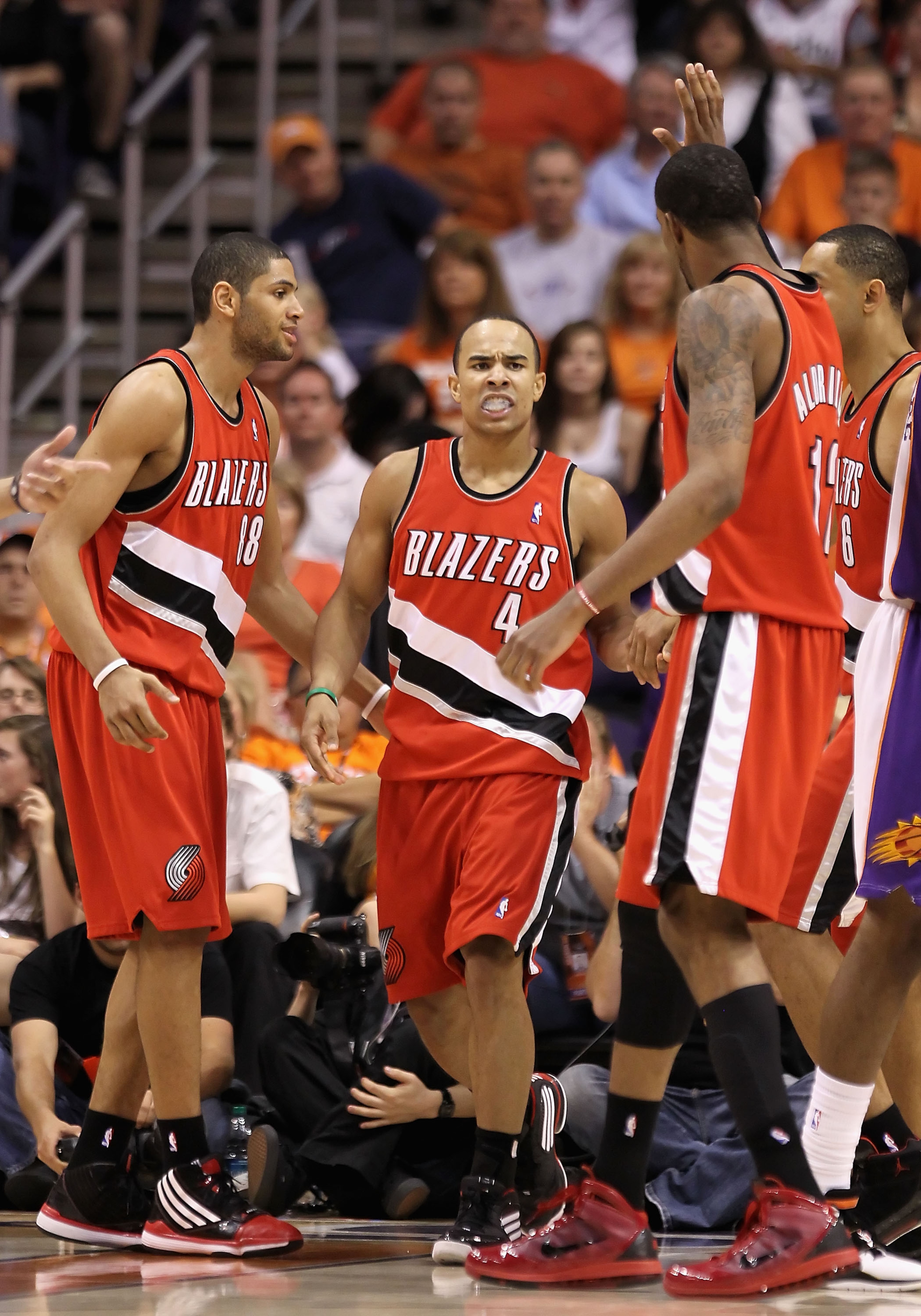PHOENIX - APRIL 18:  Jerryd Bayless #4 of the Portland Trail Blazers is congratulated by teammates Nicolas Batum #88 and LaMarcus Aldridge #12 after Bayless scored against the Phoenix Suns during Game One of the Western Conference Quarterfinals of the 201