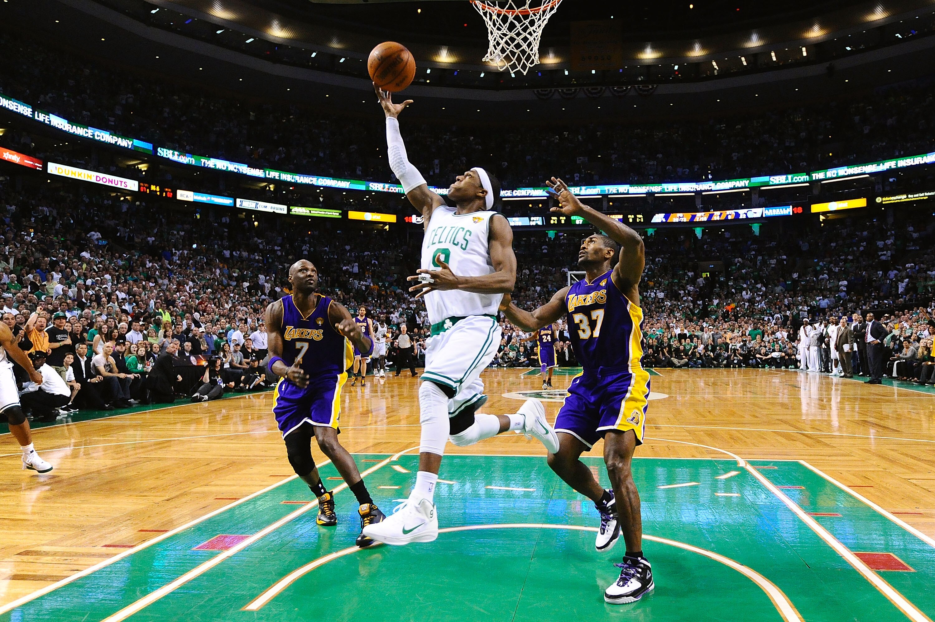 BOSTON - JUNE 13:  Rajon Rondo #9 of the Boston Celtics goes to the basket against Lamar Odom #7 and Ron Artest #37 of the Los Angeles Lakers during Game Five of the 2010 NBA Finals on June 13, 2010 at TD Garden in Boston, Massachusetts. NOTE TO USER: Use