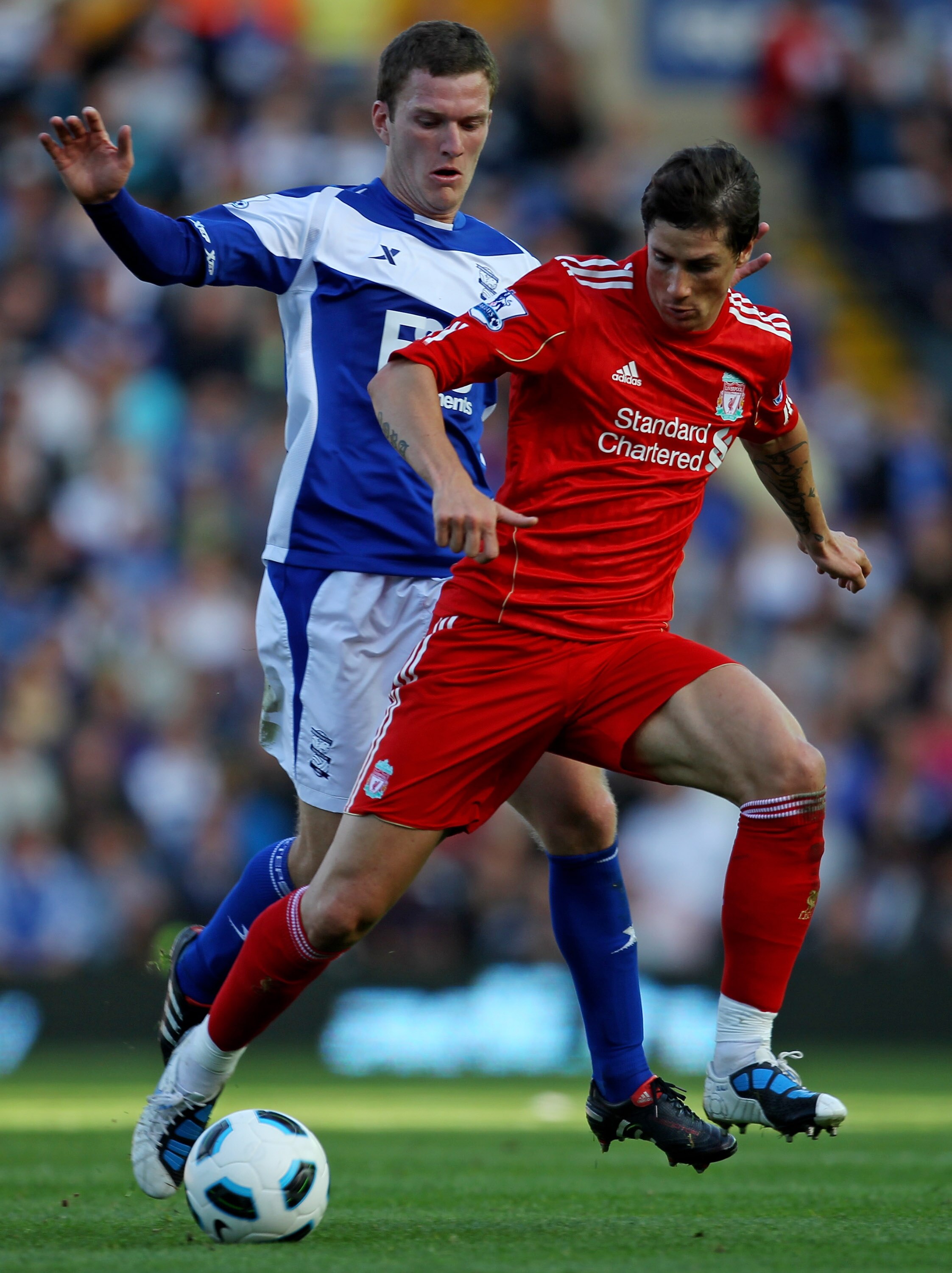 BIRMINGHAM, ENGLAND - SEPTEMBER 12:  Fernando Torres of Liverpool tussles for posession with Craig Gardner of Birmingham City during the Barclays Premier League match between Birmingham City and Liverpool at St Andrew's Stadium on September 12, 2010 in Bi