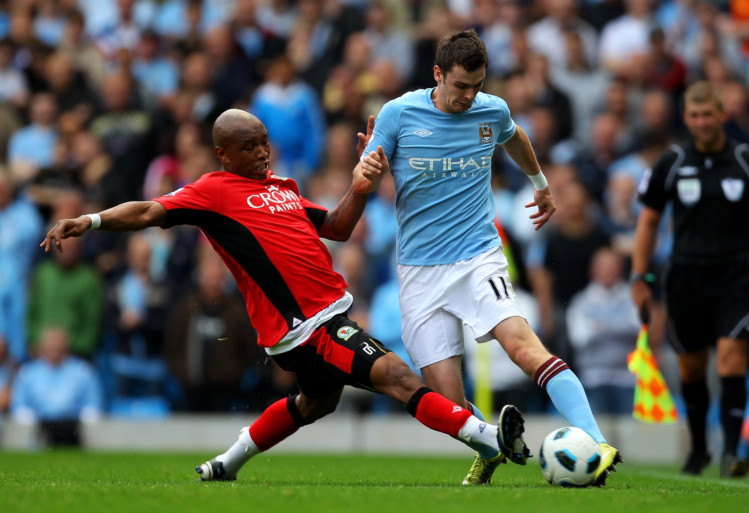 MANCHESTER, ENGLAND - SEPTEMBER 11:  Adam Johnson of Manchester City is challenged by El Hadji Diouf of Blackburn Rovers during the Barclays Premier League match between Manchester City and Blackburn Rovers at the City of Manchester Stadium on September 1